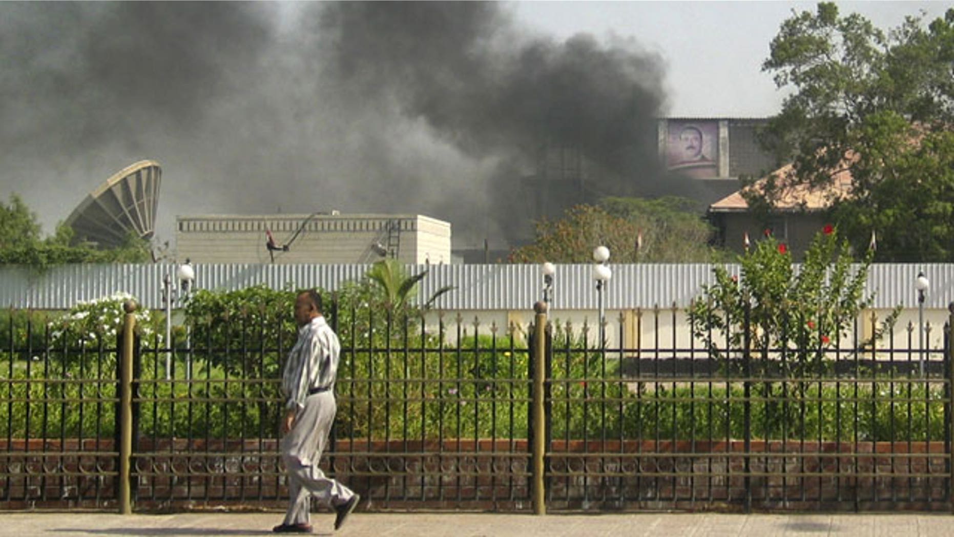 June 19: Black smoke is seen coming from the intelligence services building that came under attack in the southern port city of Aden, about 200 miles south of the capital, San'a, in Yemen.