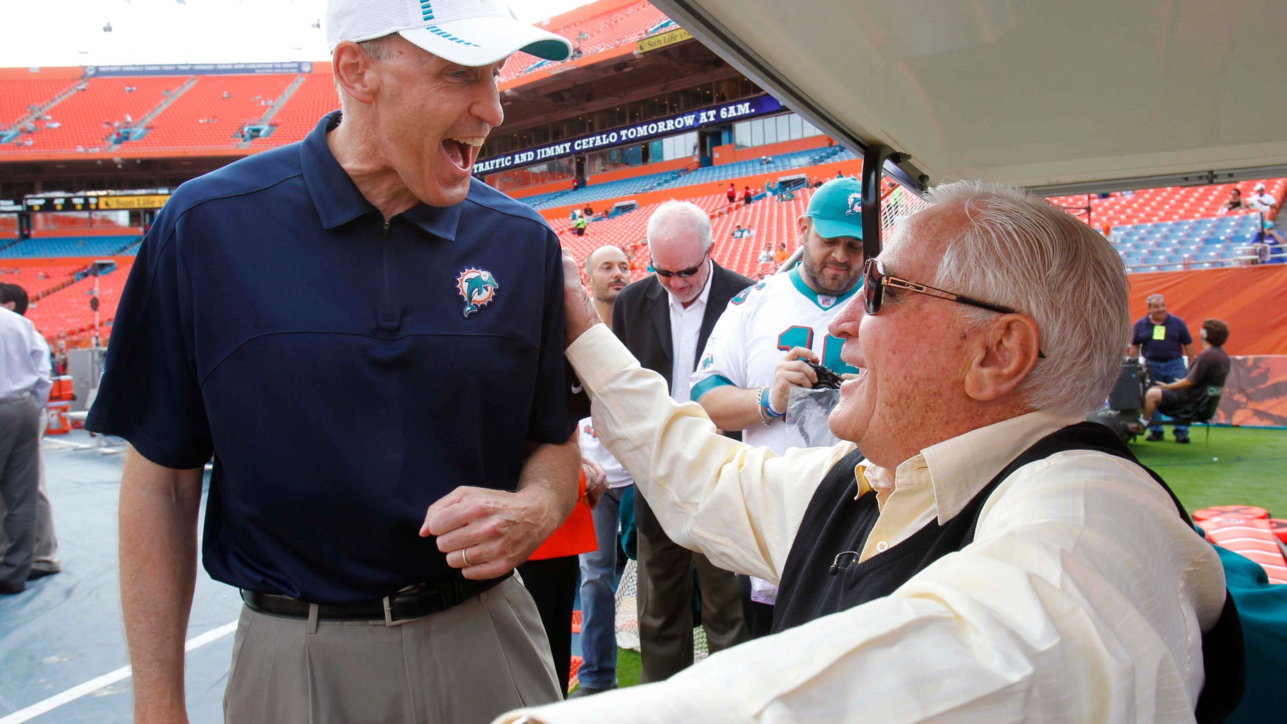 In this Sunday, Dec. 16, 2012, photo, Miami Dolphins coach Joe Philbin, left, and former coach Don Shula speak before an NFL football game, Sunday, Dec. 16, 2012, in Miami. Shula is optimistic Philbin and rookie Ryan Tannehill will put an end to years of steady turnover at the head coach and quarterback positions. (AP Photo/Wilfredo Lee)