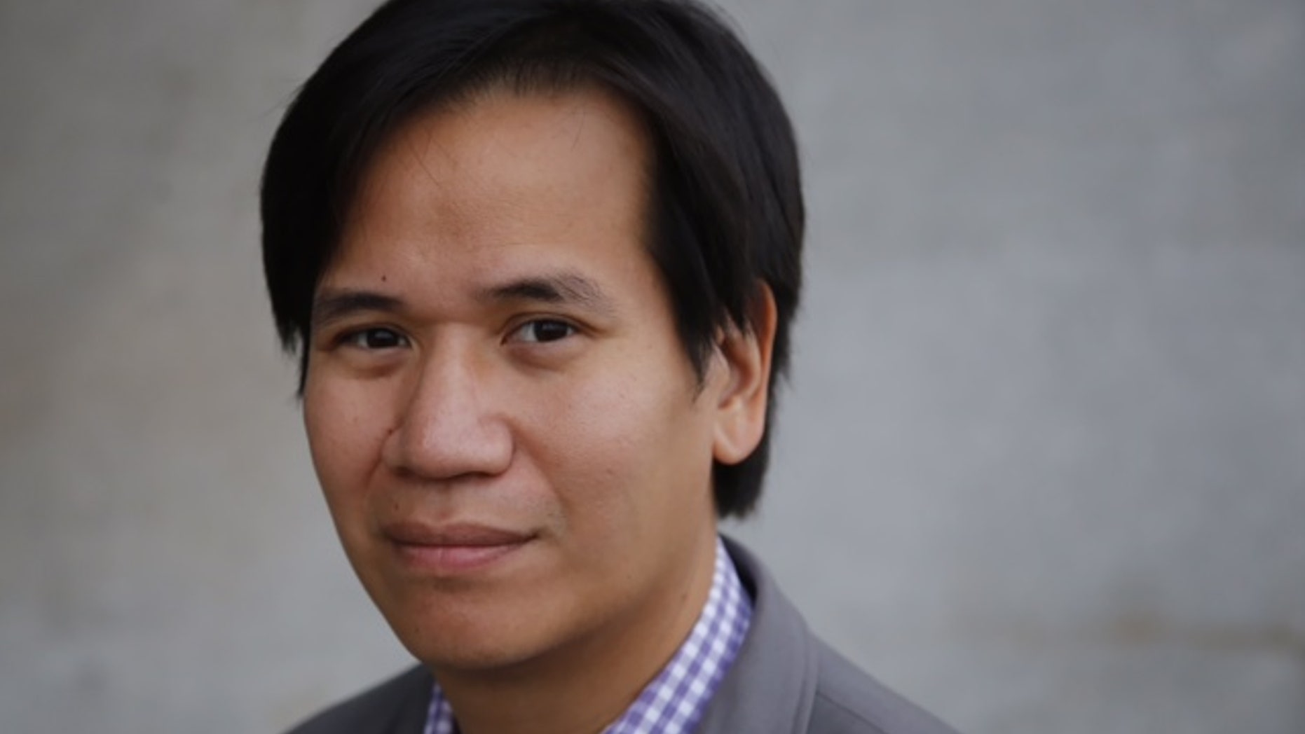 In this photo taken on Aug. 23, 2014, Washington-based Associated Press staff photographer Charles Dharapak poses for a portrait in Washington. Dharapak has been appointed the AP’s regional photo editor for the Asia-Pacific region, based in Bangkok. His appointment was announced Monday, Sept. 15, 2014 by Ted Anthony, AP’s director of Asia-Pacific news. (AP Photo)