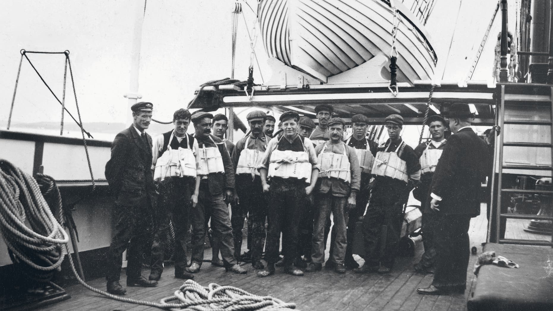 Members of the Titanic crew pose with lifejackets.