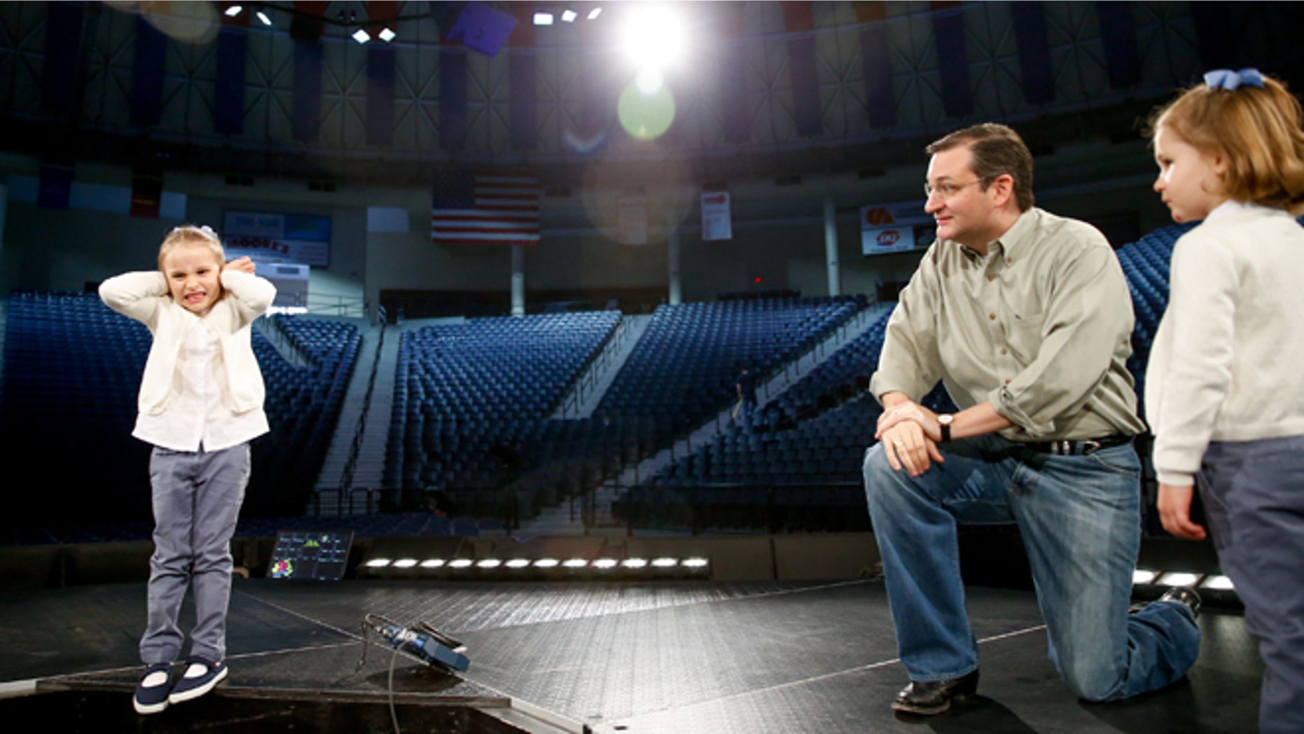 Caroline Cruz, 6, pretends to react to noise as Sen. Ted Cruz, R-Texas, tells her and her sister, Catherine, 4, right, how loud and crowded it will be for Cruz's Monday morning speech where he is expected to launch his campaign for U.S. president, during a walk-through on stage at Liberty University on Sunday, March 22, 2015 in Lynchburg, Va. Cruz will be the first major candidate in the 2016 race for president. (AP Photo/Andrew Harnik)