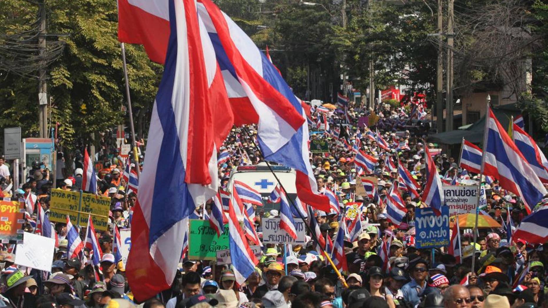 FILE - In this Jan. 18, 2014 file photo, Thai anti-government protesters march on a street during a rally in Bangkok, Thailand. Thailand's military-installed prime minister defended a new law that places tight restrictions on public gatherings and warned Thursday, Aug. 13, 2015 it will be strictly enforced. Human rights groups have voiced concern about the Public Assembly Act, which took effect Thursday, and its stiff penalties. (AP Photo/Sakchai Lalit, File)