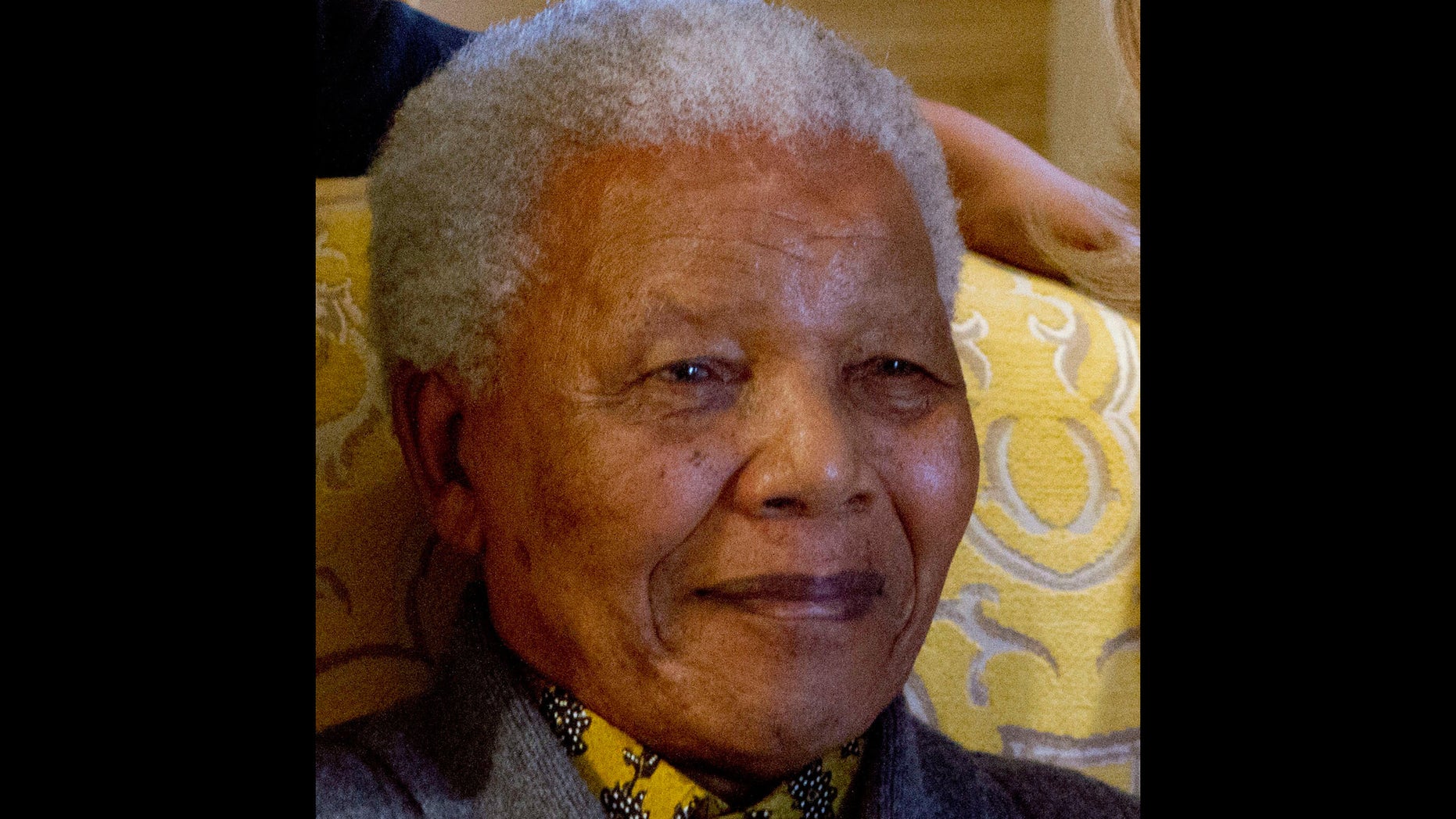FILE - This photo taken Monday Aug. 6, 2012 shows former South African President Nelson Mandela when he met with US Secretary of State Hillary Rodham Clinton, unseen, at his home in Qunu, South Africa. Mandela on Friday, Dec 14 2012 entered the seventh day of a hospital stay for a lung infection as questions grow about where he is receiving treatment. The 94-year-old patriarch of South Africa's democracy has been hospitalized since Saturday, first undergoing tests and later being diagnosed with the ailment. (AP Photo/Jacquelyn Martin, Pool, File)