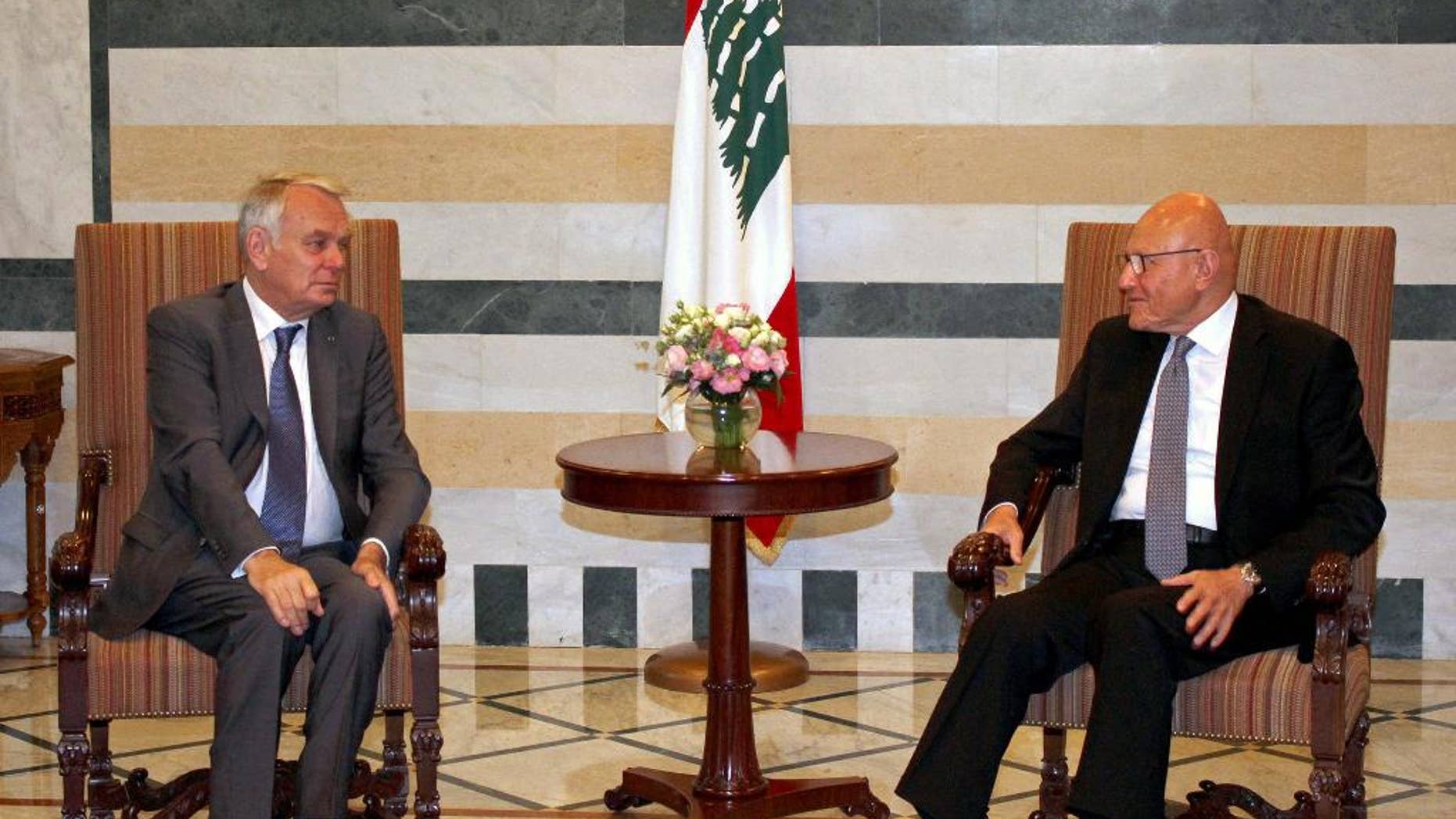 In this photo released by Lebanon's official government photographer Dalati Nohra, Lebanese Prime Minister Tammam Salam, right, meets with French Foreign Minister Jean-Marc Ayrault, left, at the government House, in Beirut, Lebanon, Tuesday, July 12, 2016. Ayrault said his country will do everything it can to help Lebanon emerge from its political stalemate. (Dalati Nohra via AP)