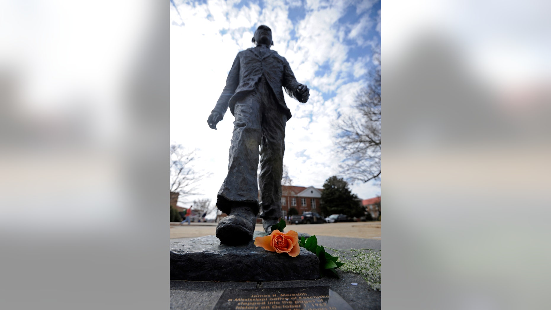A flower is seen on the James Meredith statue at the University of Mississippi in Oxford, Miss., Tuesday, Feb. 18, 2014. Campus police at the University of Mississippi are checking video surveillance footage in the area around a statue of James Meredith that was found sullied Sunday morning. (AP Photo/The Daily Mississippian, Thomas Graning)