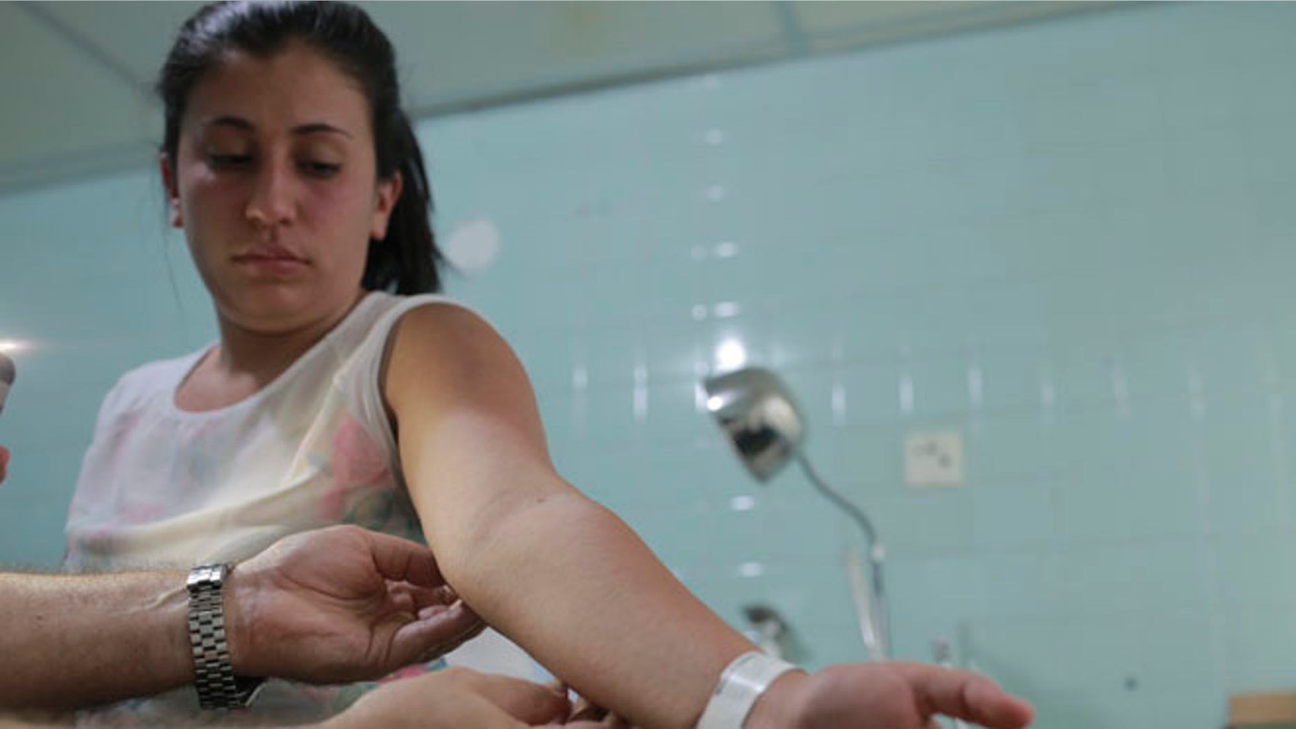 Feb. 11, 2016: A gynecologist examines a rash on the arm of six-weeks pregnant Daniela Rodriguez, 19, who was diagnosed with the Zika virus at the Erasmo Meoz Hospital in Cucuta, Colombia.