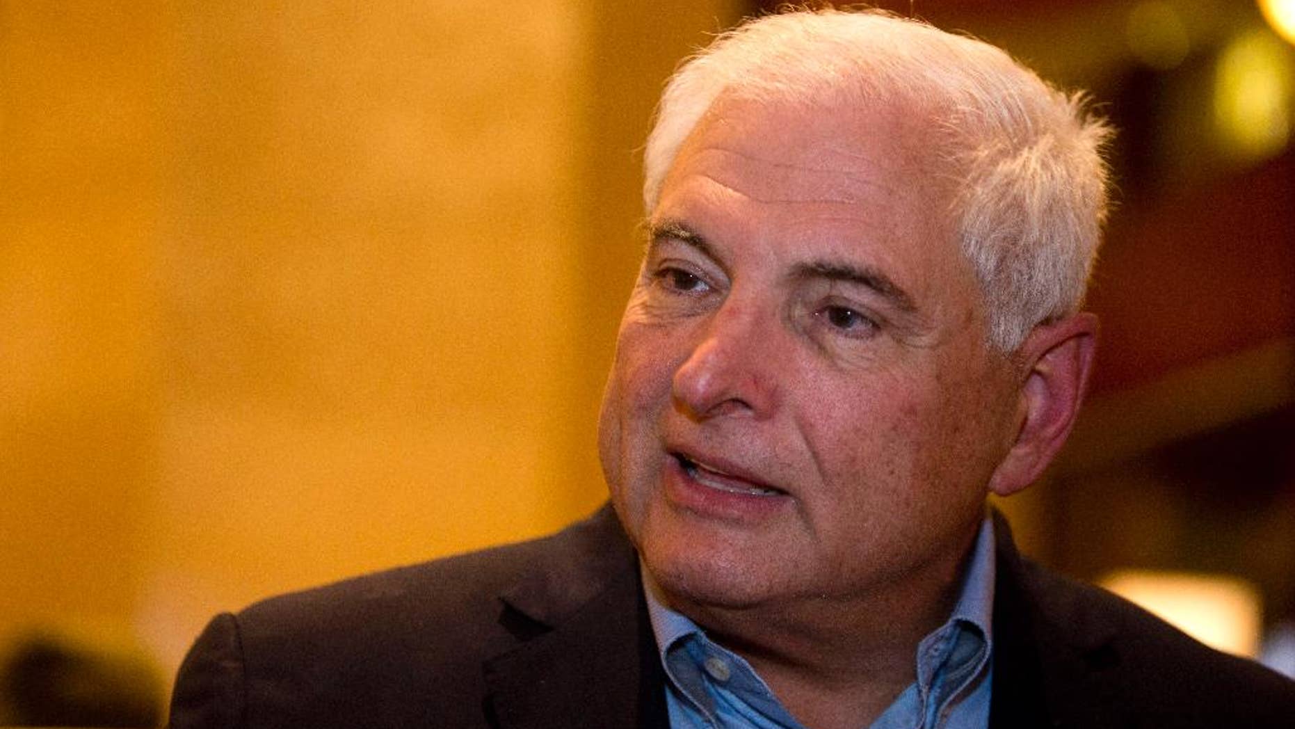 FILE - In this Jan. 28, 2015, file photo, Panama's former President Ricardo Martinelli answers questions during an interview at a hotel in Guatemala City. A judge said Friday, Dec. 11, 2015, that Martinelli is in contempt of court for failing to appear at a session in which he was expected to be charged with illegally spying on opponents. (AP Photo/Moises Castillo, File)