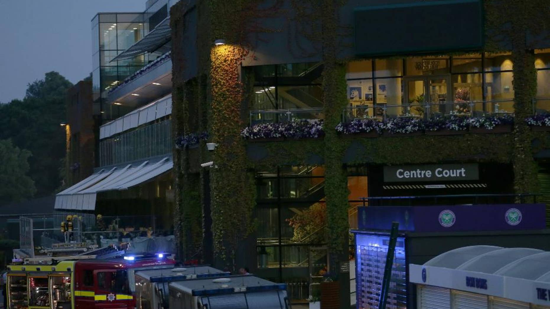 Emergency services attend an incident outside Centre Court, at the All England Lawn Tennis Championships in Wimbledon, London, Wednesday July 1, 2015. (AP Photo/Tim Ireland)