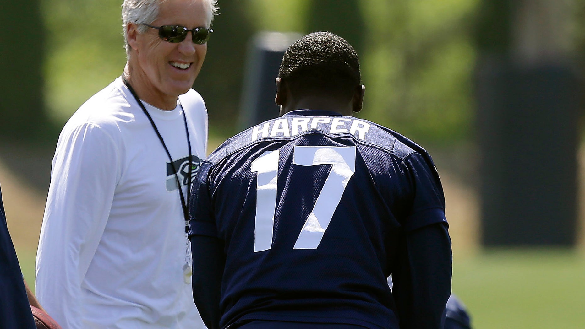 Seattle Seahawks head coach Pete Carroll, left, talks to Chris Harper during drills at NFL football rookie minicamp, Friday, May 10, 2013, in Renton, Wash. (AP Photo/Ted S. Warren)