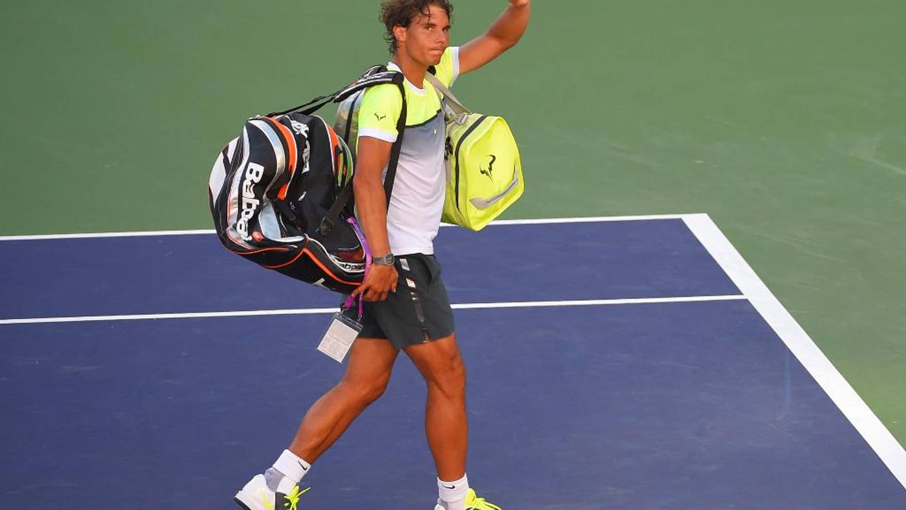 Rafael Nadal, of Spain, leaves the court after losing to Milos Raonic, of Canada, at the BNP Paribas Open tennis tournament, Friday, March 20, 2015 in Indian Wells, Calif. Raonic won, 4-6, 7-6 (10), 7-5. (AP Photo/Mark J. Terrill)