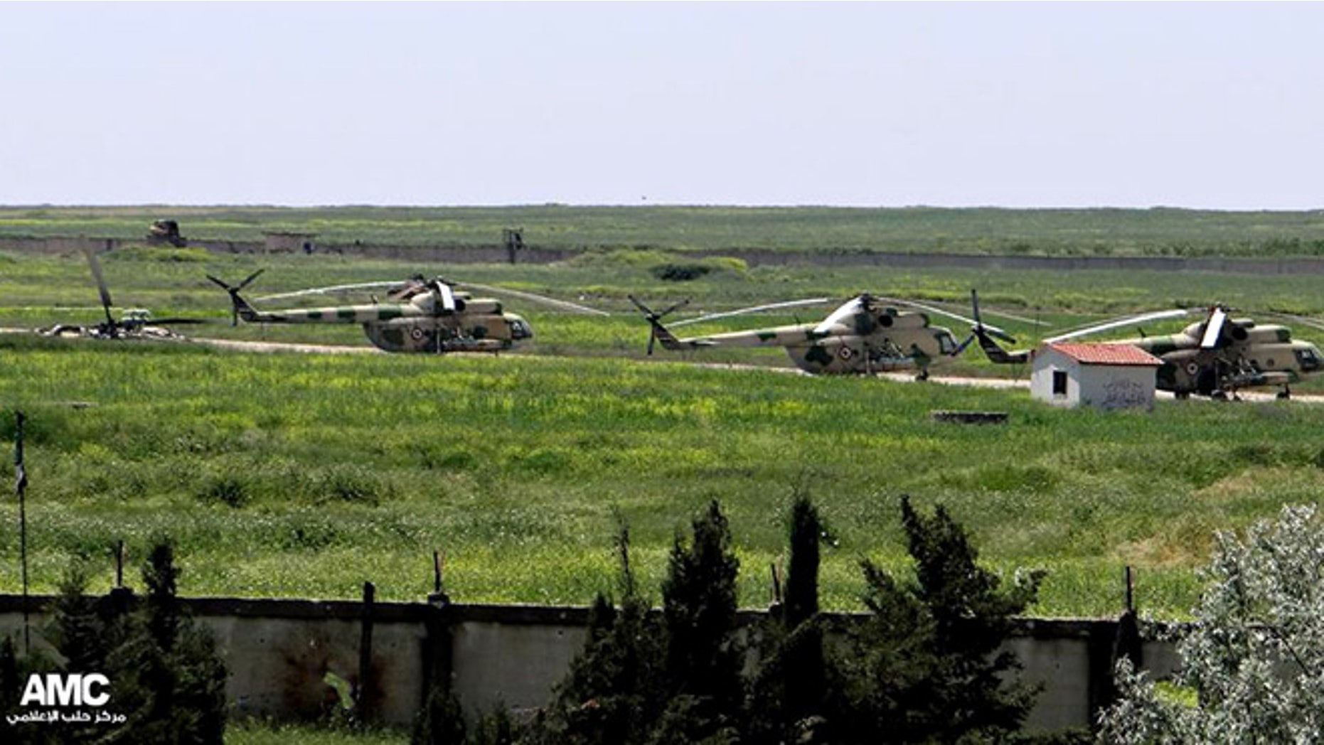 June 18, 2013: In this file photo, citizen journalism image provided by Aleppo Media Center AMC which has been authenticated based on its contents and other AP reporting, shows Syrian military helicopters at Mannagh air base in Aleppo province, Syria.