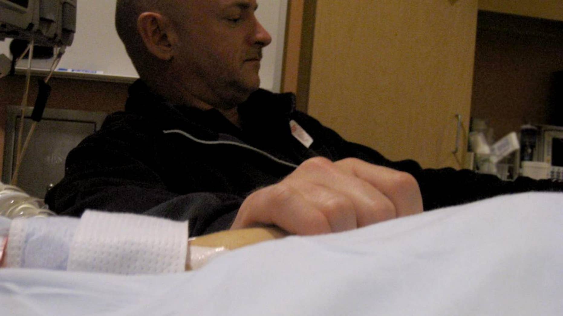 NASA astronaut Mark Kelly holds hands with his wife, AZ Rep. Gabrielle Giffords, in the Tucson hospital where she's been since she was shot January 8. (Photo Courtesy the Office of Congresswoman Gabrielle Giffords)