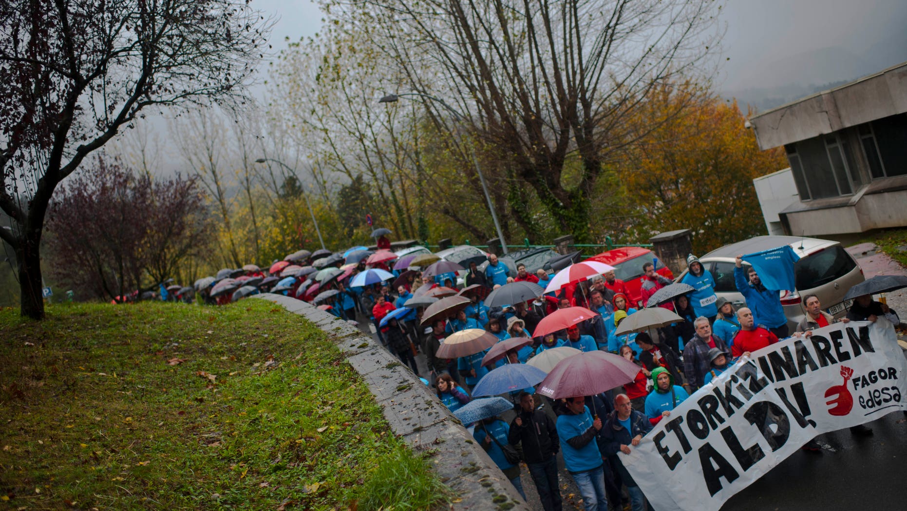 Employees of the Spanish appliance maker Fagor-Edesa Electrodomesticos protest in defense of their jobs, in Arrasate Mondragon, northern Spain, Monday Nov. 11, 2013. Fagor-Edesa, which claims to be Europe's fifth-largest appliance maker and has nearly 6,000 employees, has filed for bankruptcy protection after years of economic crisis caused a dramatic drop in sales. The company, part of the Basque region's Mondragon cooperative, has said it was unable to find financing to pay off an unspecified amount of debt. Banner reads:, "For Our Future". (AP Photo/Alvaro Barrientos)