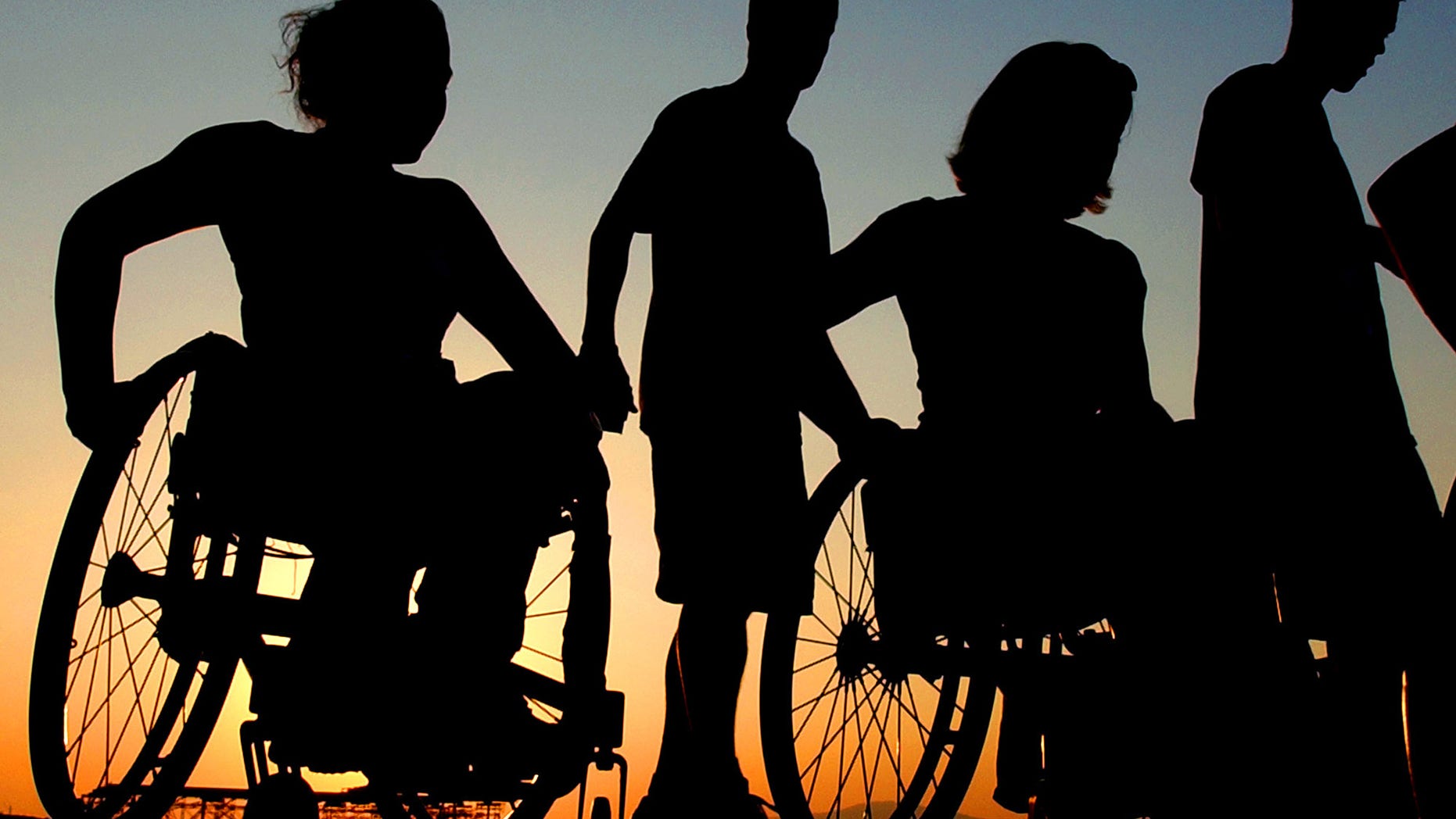 Members of the U.S. women's track and field Paralympic team, in wheelchairs, visit the Acropolis Hill with escorts, in Athens on Wednesday, Sept. 15, 2004. The Athens Paralympics start Friday. (AP Photo/Petros karadjias)