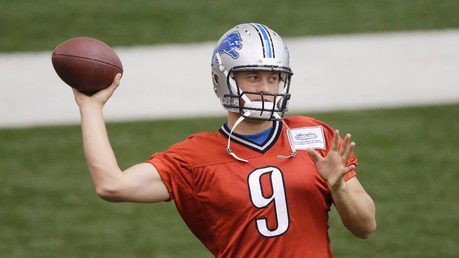Detroit Lions quarterback Matthew Stafford throws during an NFL football training camp, Monday, Aug. 11, 2014, in Allen Park, Mich. (AP Photo/Carlos Osorio)