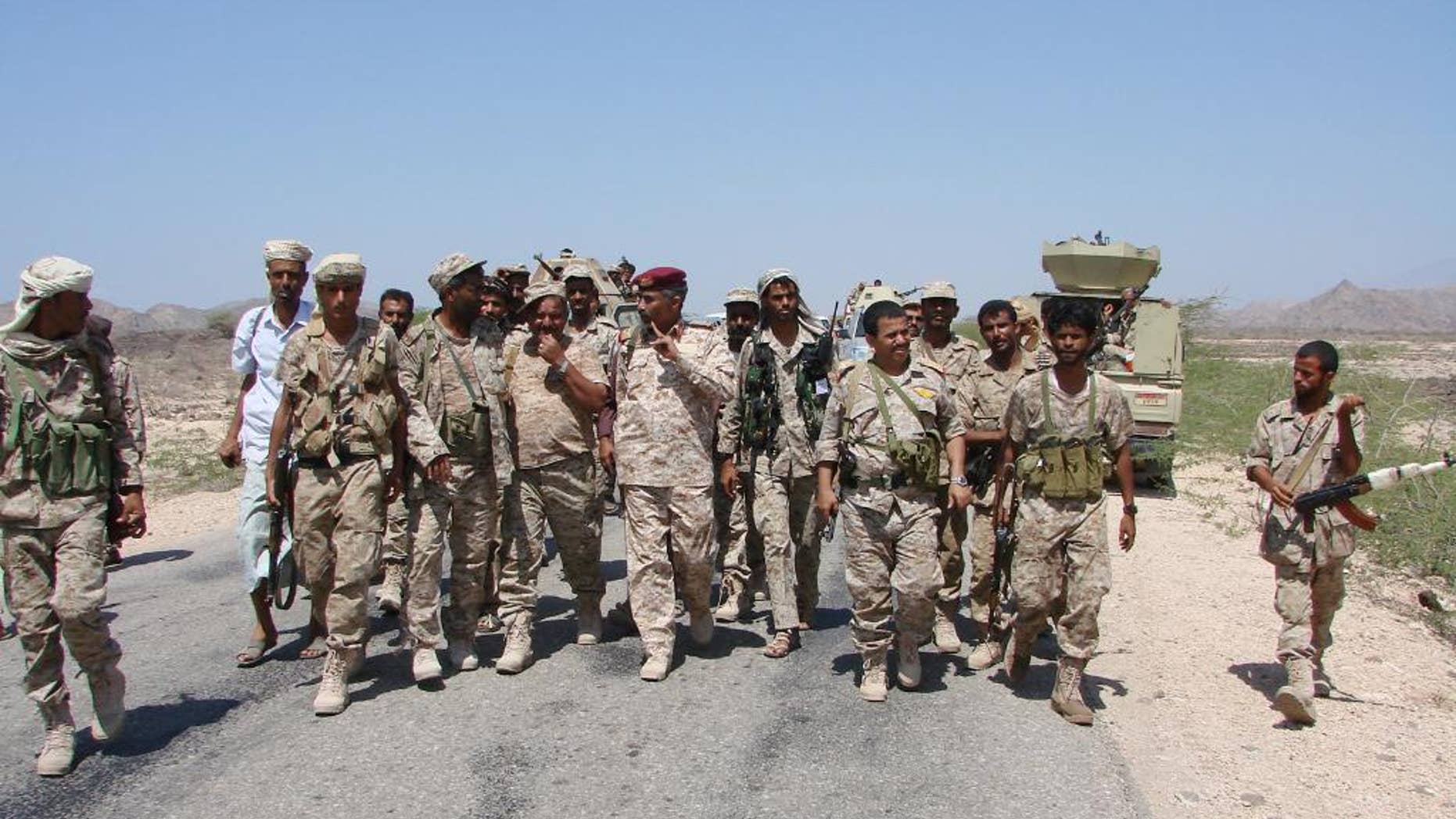 In this Friday, May 1, 2014, photo provided by Yemen's Defense Ministry, army officers and soldiers patrol a road during fighting with al-Qaida militants in Majala of the southern province of Abyan, Yemen. (AP Photo/Yemen's Defense Ministry)