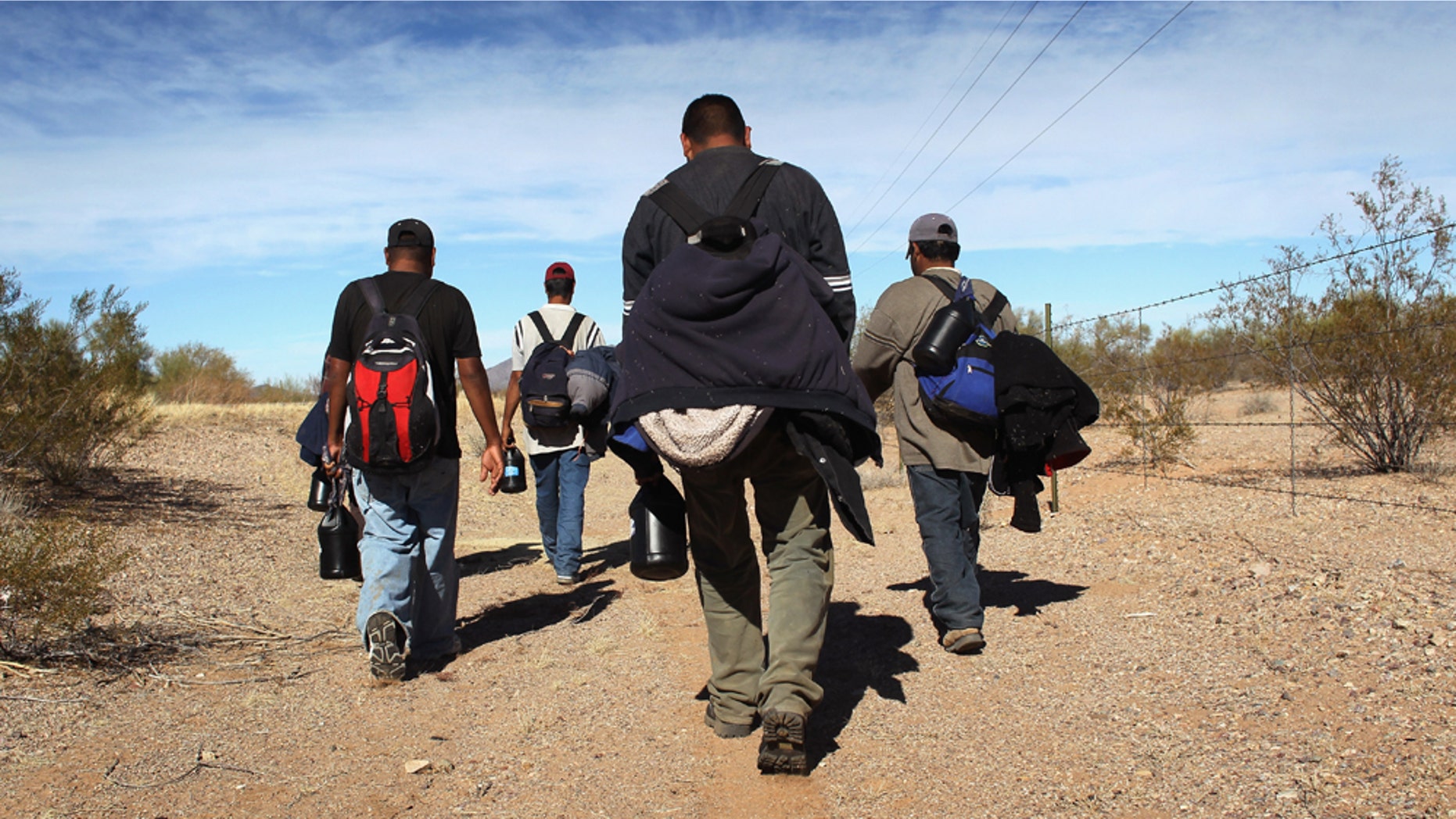 TOHONO O'ODHAM NATION, AZ - JANUARY 19: Undocumented Mexican immigrants walk through the Sonoran Desert after illegally crossing the U.S.-Mexico border border on January 19, 2011 into the Tohono O'odham Nation, Arizona. The immigrants said they had wandered the desert lost for a week after crossing from Mexico into the vast Indian reservation at night. Exhausted, they requested the Border Patrol to pick them up and take them to the U.S.-Mexico border, from where they would return to their homes in the Mexican state of Sonora. They had come, they said, to reach Phoenix and find work in construction or landscaping. All said they had worked in Arizona before. (Photo by John Moore/Getty Images)