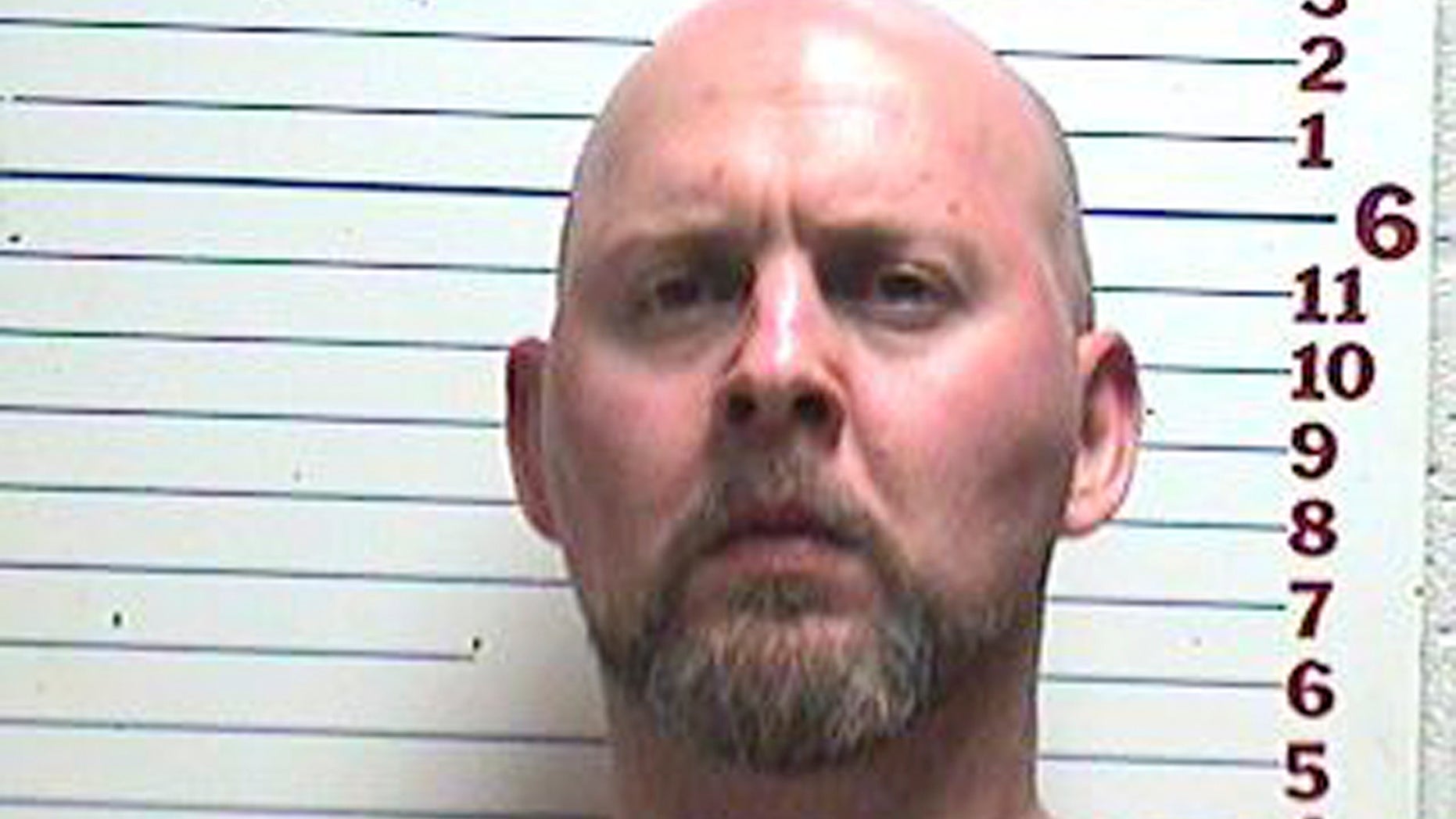 In this photo provided by the Comanche County Detention Center, David Lee Kemp is pictured in a booking photo dated April 26, 2013. Authorities in southwest Oklahoma say they've captured Kemp, a murder suspect who's been on the run since a brazen jail escape with eight other inmates in 1999. Kemp was the only inmate to elude capture after escaping the Comanche County jail on March 11, 1999. He was awaiting trial on two first-degree murder counts in the killings of his ex-wife and another man. (AP Photo/Comanche County Detention Center)
