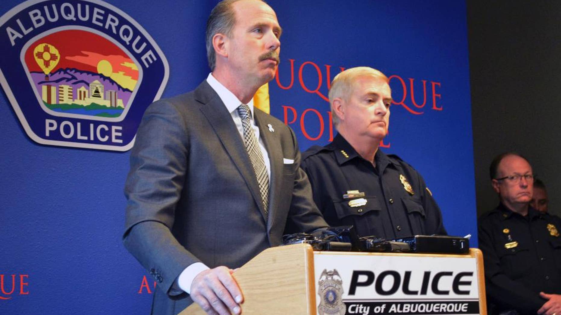 In this Tuesday, Dec. 6, 2016 photo, Albuquerque Mayor Richard Berry, left, and Police Chief Gorden Eden, right, speak at a press conference in Albuquerque, N.M. The U.S. Attorney's Office said Thursday the U.S. Department of Justice is investigating whether Albuquerque police lapel camera videos have been altered or deleted. (AP Photo/Russell Contreras)