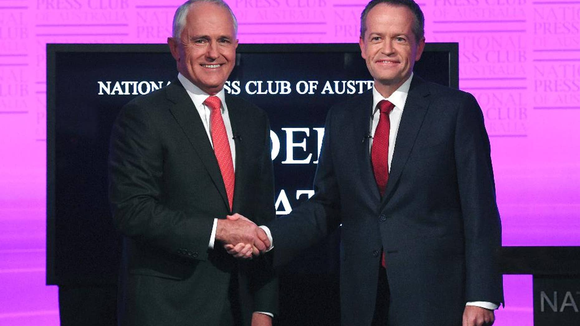 FILE - In this May, 29, 2016 file photo, Australian Prime Minister Malcolm Turnbull, left, and opposition leader Bill Shorten shake hands as they arrive for the leaders' debate at the National Press Club in Canberra. Turnbull said Tuesday, June 7 that he had reached an agreement with Facebook and News Corp. Australia to stream the debate early next week in a bid to reach more voters. Shorten later agreed to participate. (Tracey Nearmy/Pool Photo via AP, File)