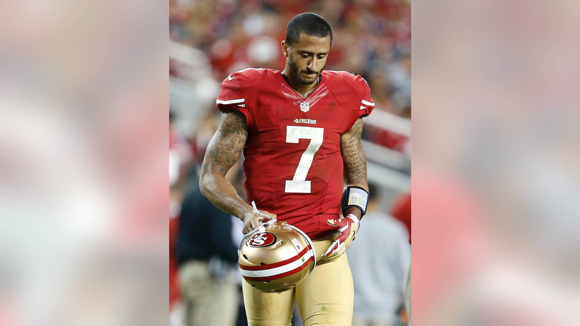 San Francisco 49ers quarterback Colin Kaepernick (7) walks on the field during the fourth quarter of an NFL football game against the Chicago Bears in Santa Clara, Calif., Sunday, Sept. 14, 2014. (AP Photo/Tony Avelar)