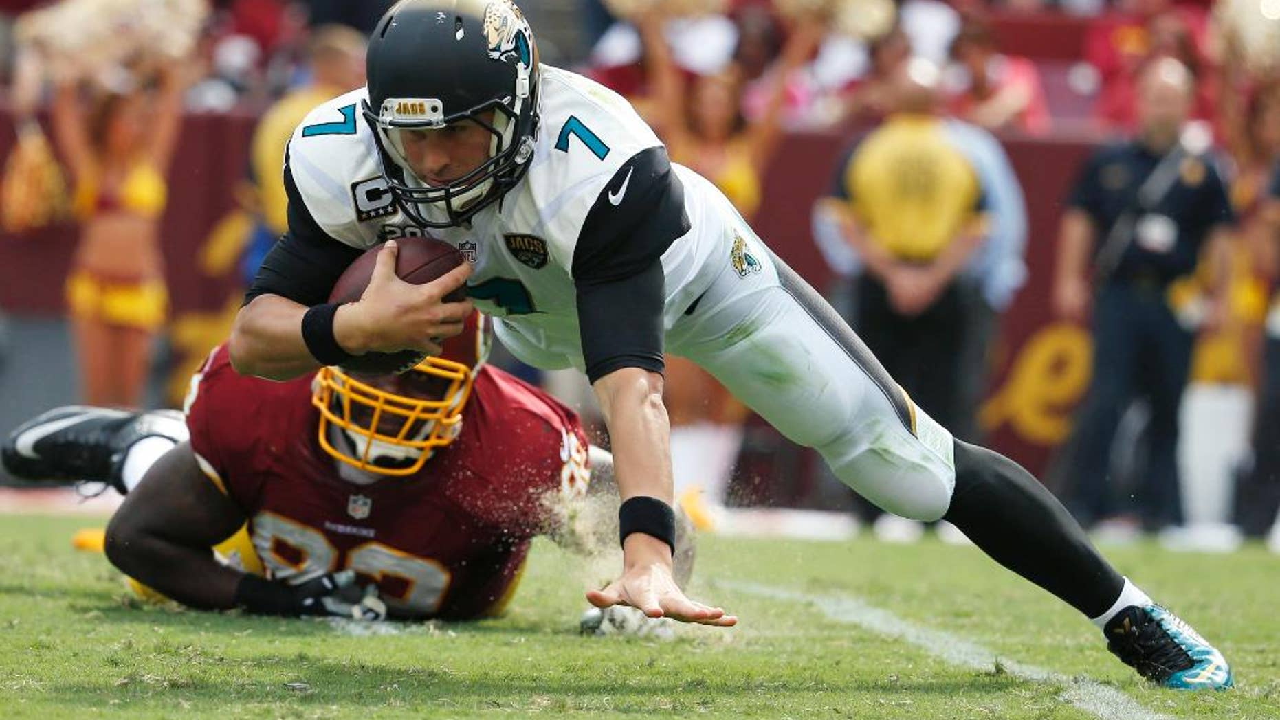 Jacksonville Jaguars quarterback Chad Henne (7) is sacked by Washington Redskins defensive end Chris Baker (92) during the second half of an NFL football game Sunday, Sept. 14, 2014, in Landover, Md. The Redskins won 41-10. (AP Photo/Evan Vucci)