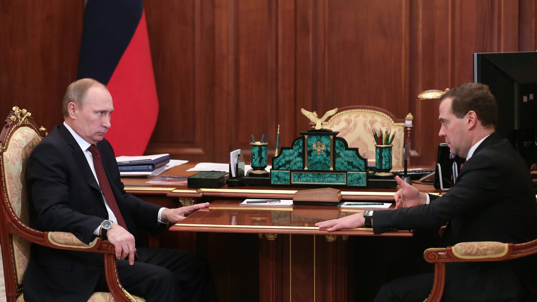 Russian President Vladimir Putin, left, speaks during a meeting with Premier Dmitry Medvedev in Moscow's Kremlin Monday, Dec. 30, 2013. Putin met with officials Monday to discuss the bombings in Volgograd. (AP Photo/RIA Novosti, Mikhail Metzel, Presidential Press Service)