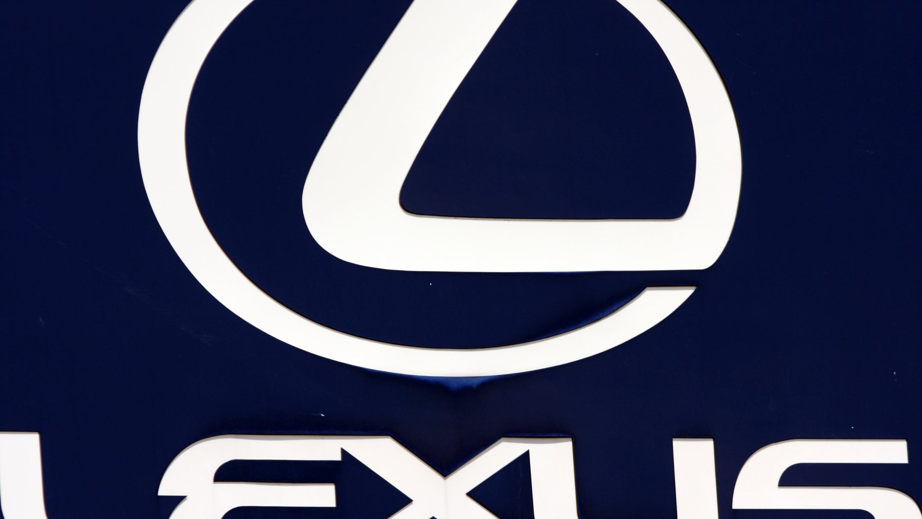 FILE - In this April 13, 2010 file photo, the Lexus logo is seen on a sign at a dealership in Portland, Maine. Toyota is recalling 907,000 vehicles, mostly Corolla models, around the world for faulty air bags and another 385,000 Lexus IS luxury cars for defective wipers. Toyota Motor Corp. spokesman Naoto Fuse said Wednesday, Jan. 30, 2013, there have been no accidents or injuries related to either of those defects, but the Japanese automaker received 46 reports of problems involving the air bags from North America, and one from Japan. There were 25 reports of problems related to the windshield wipers. (AP Photo/Pat Wellenbach, File)