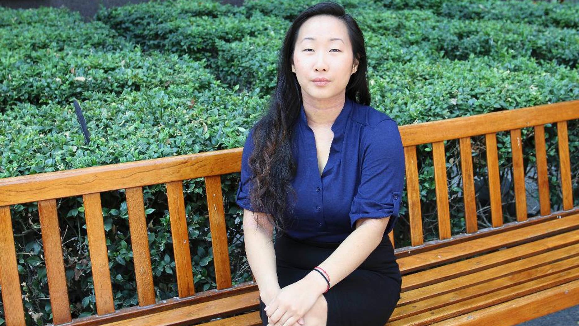 Yee Xiong, 24, sits for a photo at her attorney's office in Sacramento, Calif., on Aug. 12, 2016. As she prepared to leave the sentencing hearing for Lang Her, who she said sexually assaulted her when they were students, she felt ready to finally put the case behind her after four years. Then, she was handed a $4 million defamation lawsuit. (AP Photo/Darcy Costello)