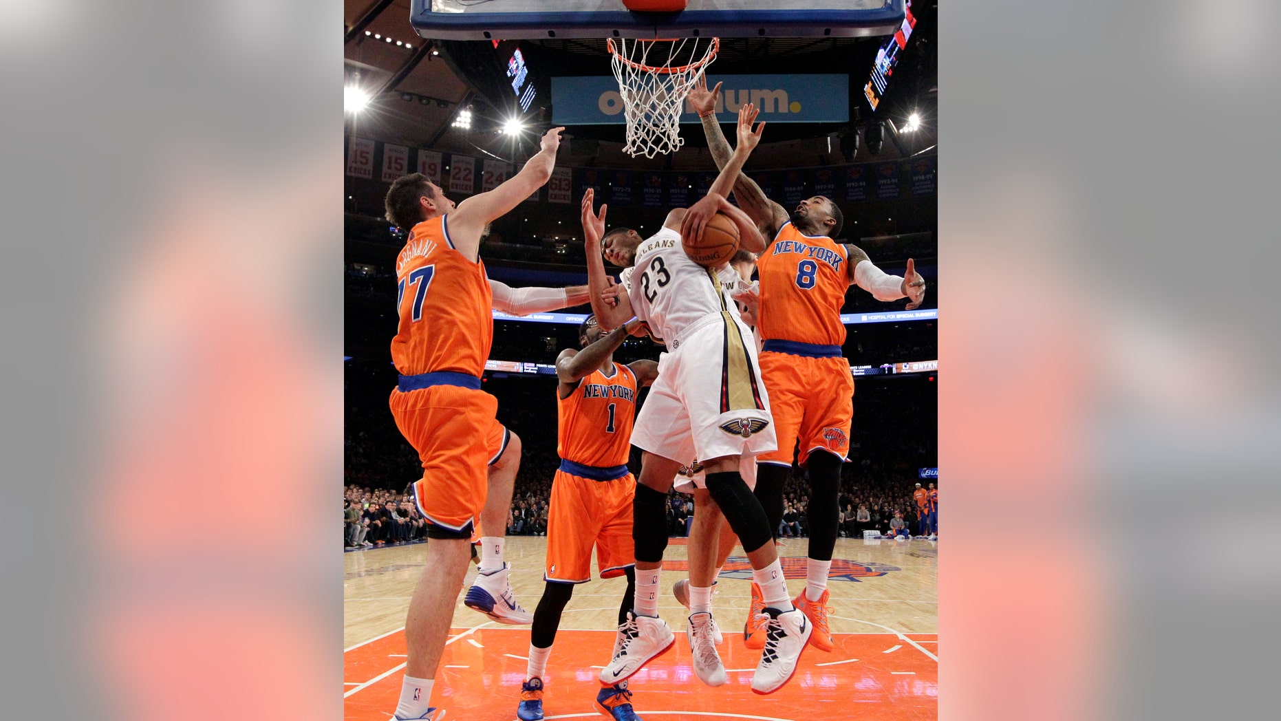 New York Knicks forward Andrea Bargnani, left, of Italy, and New York Knicks guard J.R. Smith (8) defend as New Orleans Pelicans forward Anthony Davis (23) pulls down a rebound in the first half of an NBA basketball game in New York, Sunday, Dec. 1, 2013. The Pelicans won 103-99, but Davis left the game in the first half with a fractured hand. New York Knicks forward Amar'e Stoudemire (1) defends from the floor. (AP Photo/Kathy Willens)