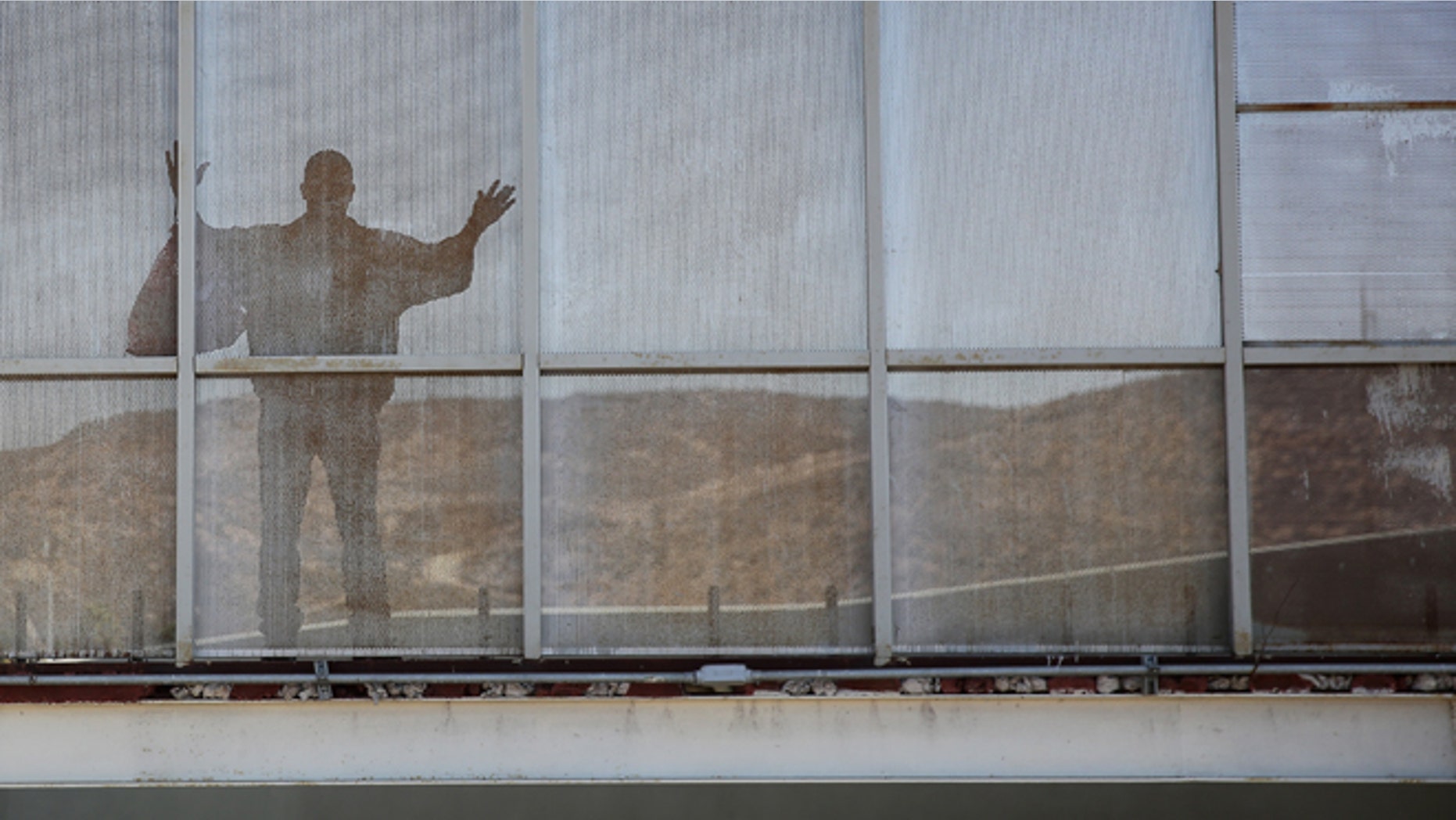 TIJUANA, MEXICO - OCTOBER 02: A deported immigrant pauses while crossing back into Mexico after being deported by U.S. immigration authorities on October 2, 2013 to Tijuana, Mexico. Despite the U.S. federal shutdown, most border agents have been categorized as essential personnel and continue working. (Photo by John Moore/Getty Images)