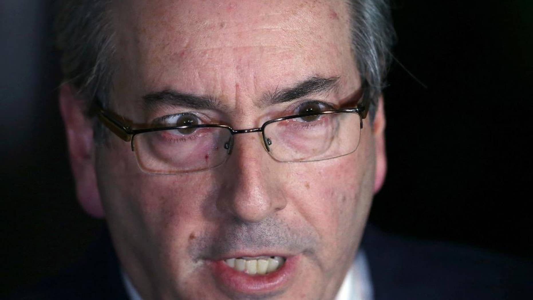 FILE - In this May 5, 2016 file photo, Brazil's President of the Chamber of Deputies Eduardo Cunha speaks during a press conference in Brasilia, Brazil. Cunha, the man who led efforts to impeach Brazil's suspended President Dilma Rousseff, has resigned as speaker of the lower house of congress. He said he hopes it ends the chaos in Brazil's congress. Judges already had suspended Cunha over allegations of obstructing justice and holding Swiss bank accounts worth millions of dollars in bribe. (AP Photo/Eraldo Peres, File)