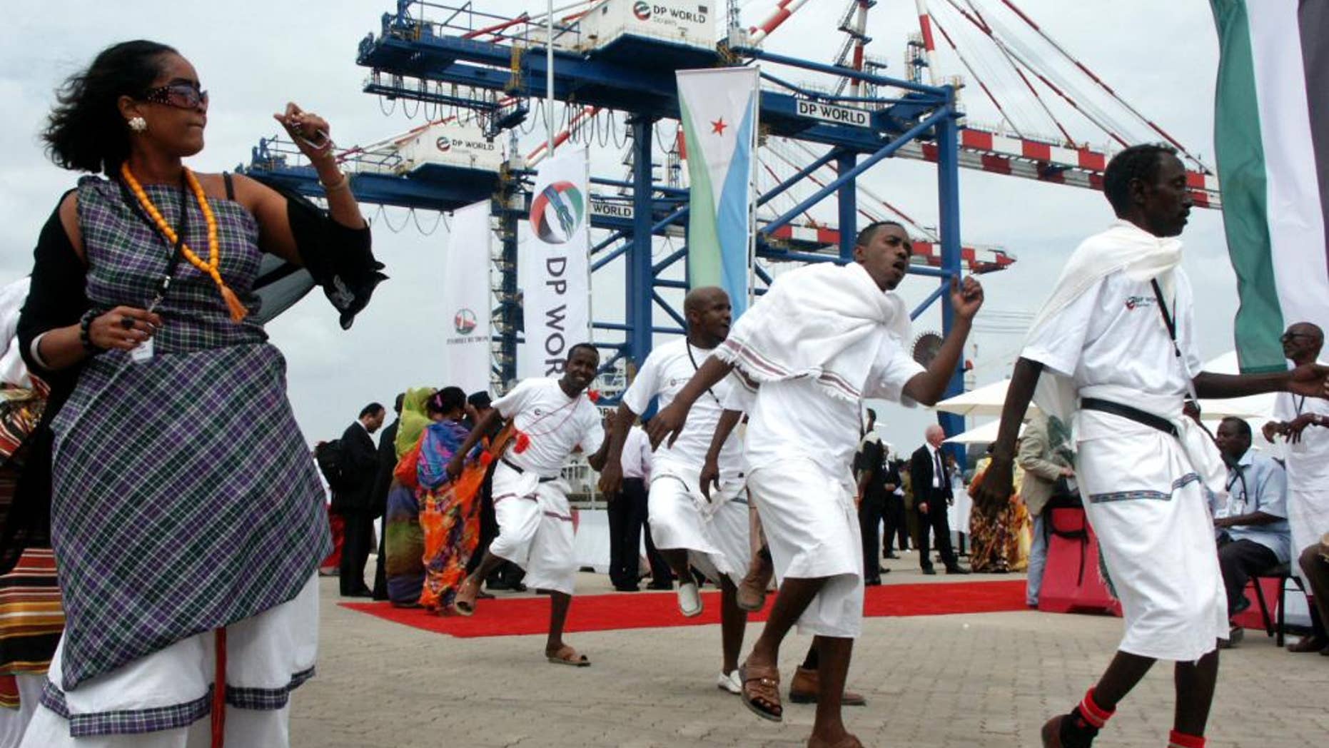 FILE -- In this Feb. 7, 2009 file photo, Djibouti men and women dance during the opening ceremony of Dubai-based port operator DP World's Doraleh container terminal in Djibouti port. Dubai's government media office said Tuesday, Feb. 21, 2017, that an arbitration tribunal has cleared port operator DP World of allegations of wrongdoing over its operation of an East African port. The government of Djibouti brought a legal challenge against Dubai's state-backed DP World in 2014 over its 50-year deal to operate the Doraleh Container Terminal, accusing it of bribing the head of Djibouti's port authority. (AP Photo/Adam Schreck, File)