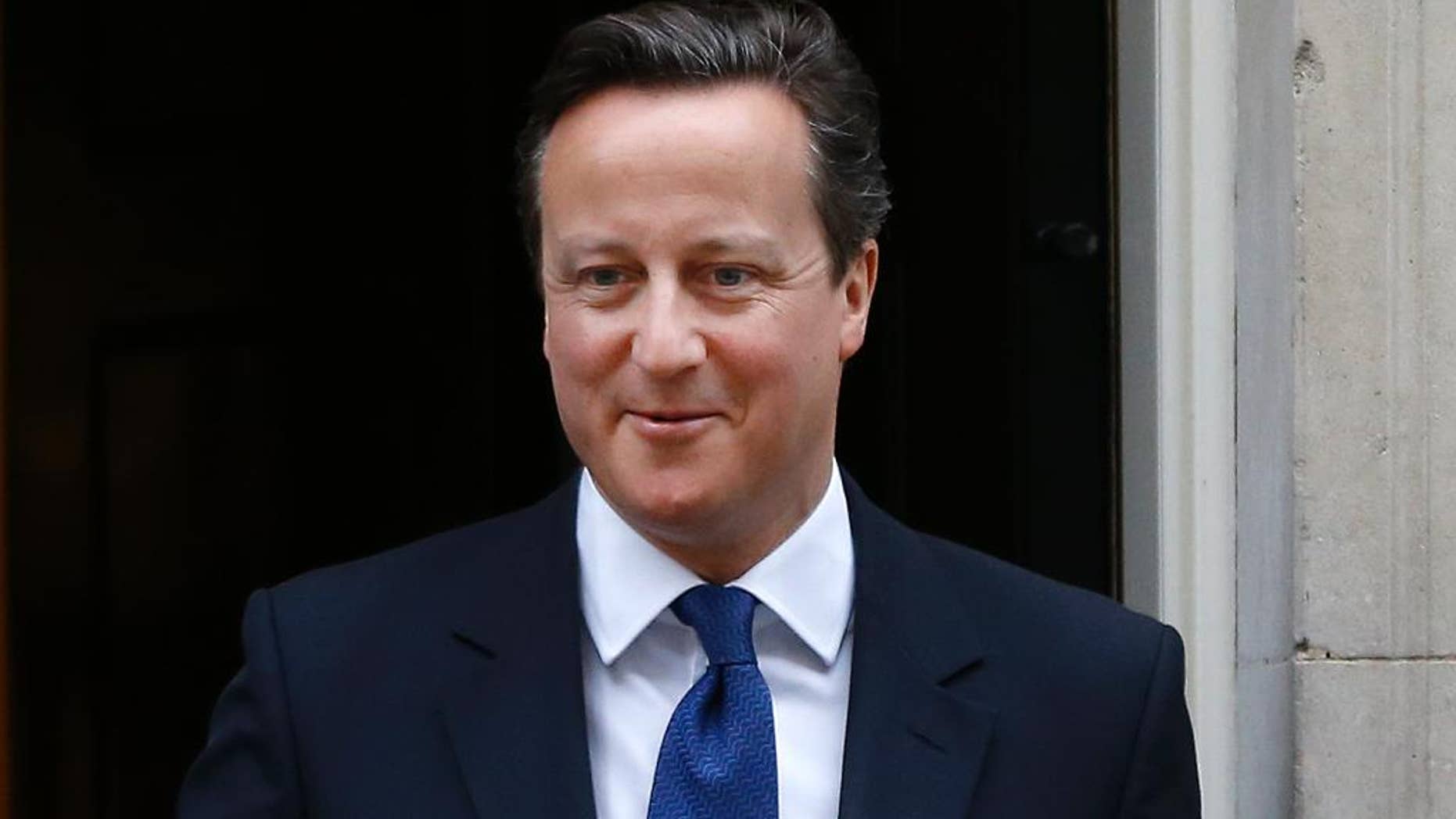 Britain's Prime Minister David Cameron leaves Downing Street to attend the weekly session of Prime Ministers Questions in parliament in London, Wednesday, Jan. 21, 2015. (AP Photo/Kirsty Wigglesworth)