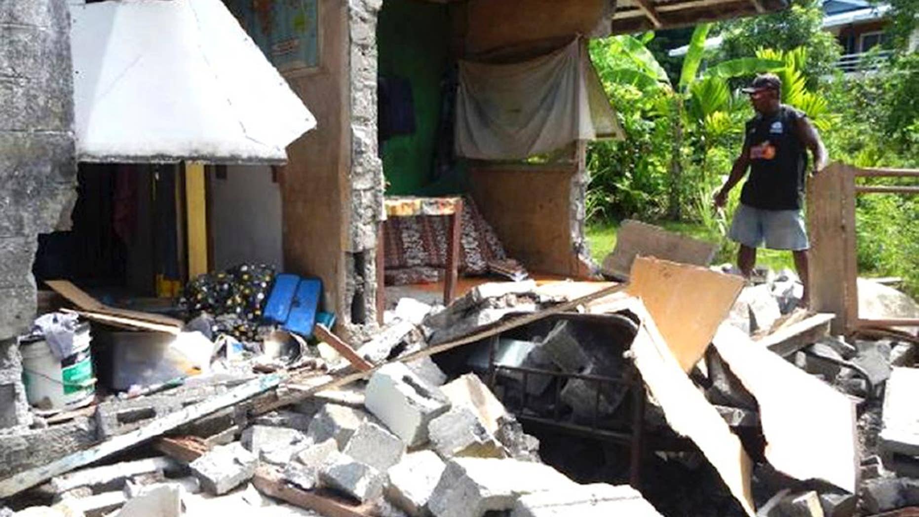 In this photo provided by World Vision Solomon Islands, a house in Kirakira, Solomon Islands, is damaged after an earthquake on Friday, Dec. 9, 2016. Tsunami warnings for several Pacific islands, including those in Hawaii, were canceled Friday after authorities determined that a powerful magnitude 7.7 earthquake that struck near the Solomon Islands did not pose a broad tsunami threat. (Gray Nako/World Vision Solomon Islands via AP)