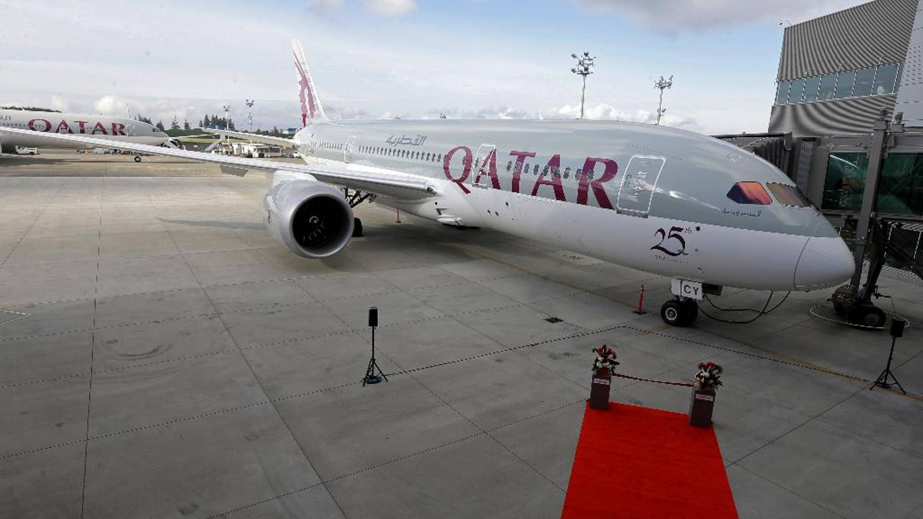 FILE -- In this Nov. 4, 2015 file photo, a Boeing 787 airplane purchased by Qatar Airways is shown during a delivery ceremony in Everett, Wash. Qatar Airways, one of the Middle East's biggest carriers, announced Sunday, July 10, 2016, net profits of $445 million in 2016, up from $103 million the previous year. It says the airline's revenue rose from $9.3 billion in 2015 to $9.6 billion. Qatar Airways Group Chief Executive Akbar Al-Baker said it was the 19-year-old airline's best fiscal year to date. (AP Photo/Ted S. Warren, File)