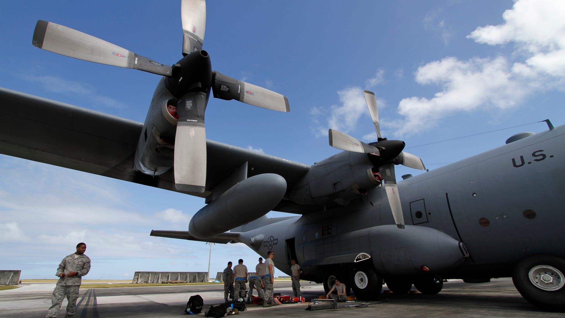 FILE - In this Feb. 7, 2013 file photo, members of the 374th Airlift Wing of U.S. Air Force work on a C-130 aircraft during the Cope North military exercises at Andersen U.S. Air Force Base in Guam. There soon will be another military element to life on the U.S. territory _ a defense system will be installed to shoot down incoming missiles and warheads. Its deployment comes amid intensifying threats from North Korea, which recently listed Guam among its targets for a nuclear attack on the United States. (AP Photo/Koji Ueda, File)