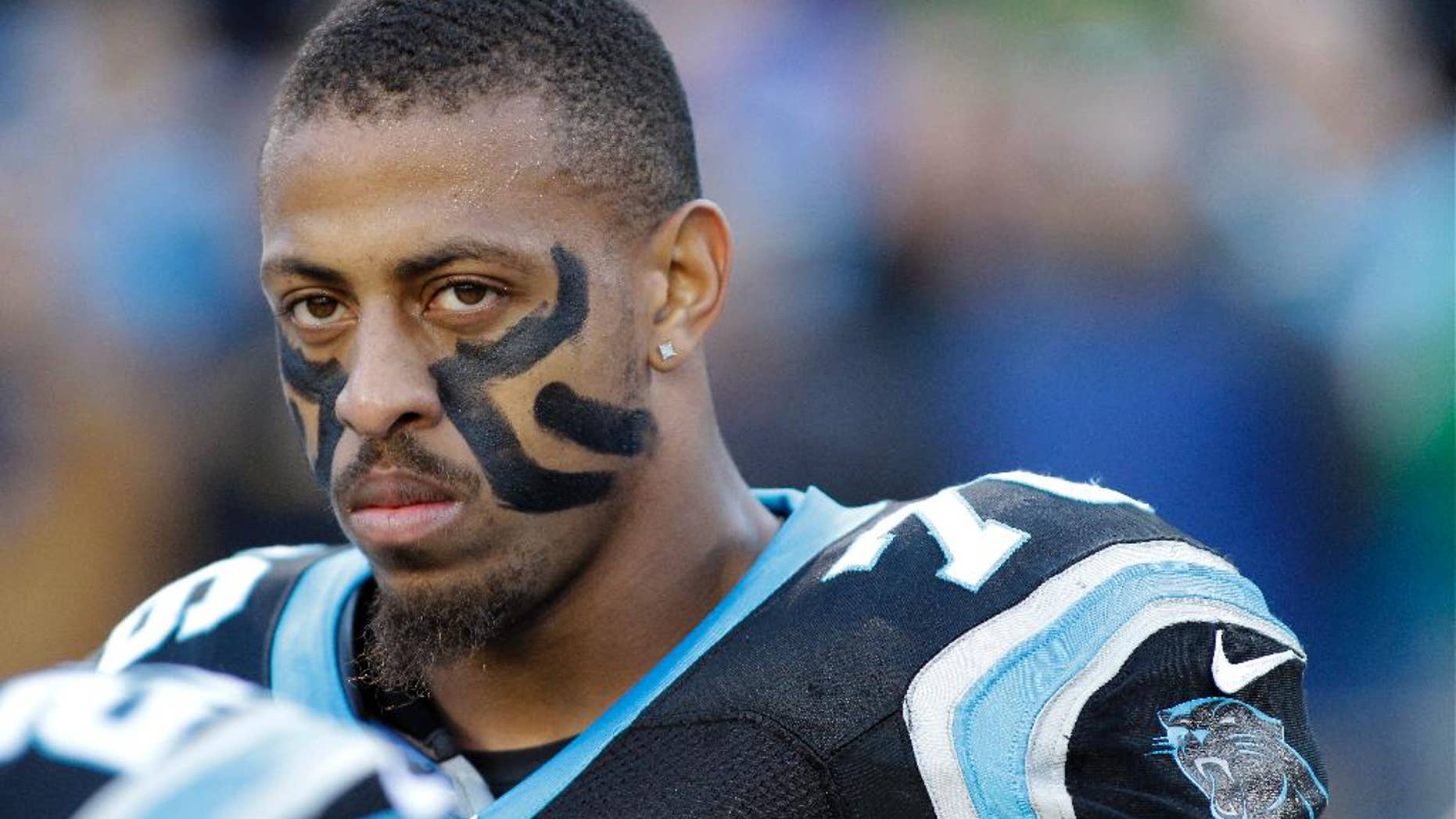 FILE - In this Dec. 15, 2013, file photo, Carolina Panthers' Greg Hardy watches before an NFL football game against the New York Jets in Charlotte, N.C. The Panthers announced Wednesday, Sept. 17, 2014, that they've placed Hardy on the exempt-commissioner's permission list, meaning the Pro Bowl defensive end has been removed from the team's active roster until his domestic violence case is resolved. (AP Photo/Bob Leverone, File)