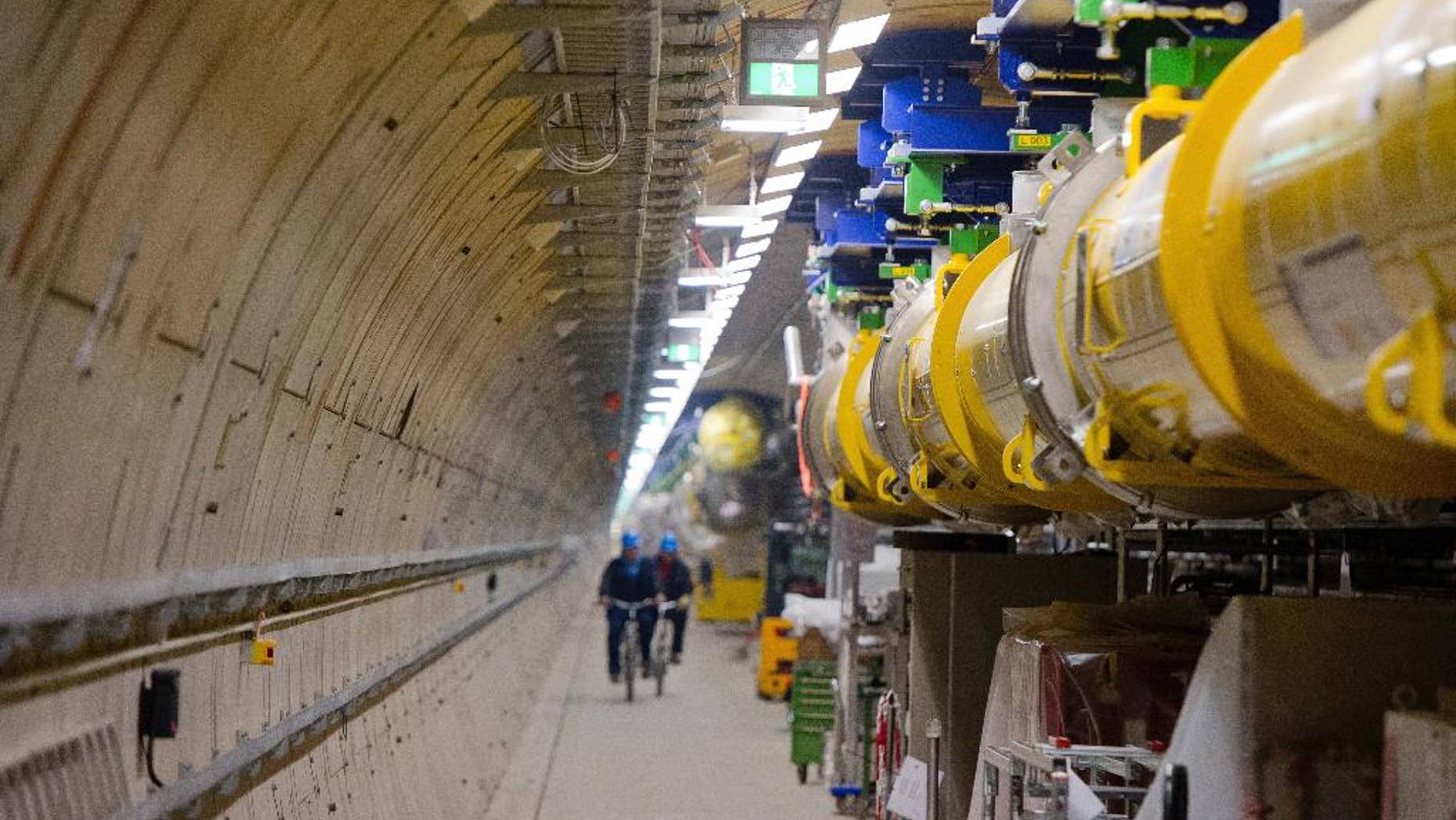 FILE - In this Feb. 18, 2015 file photo employees ride their bicycles inside the particle accelerator tunnel of the X-ray laser-project European XFEL on the outskirts of Hamburg, Germany. Researchers said Wednesday, April 19, 2017 they have reached a significant milestone on the path to beginning scientific operations later this year. (Daniel Bockwoldt/dpa via AP, file)