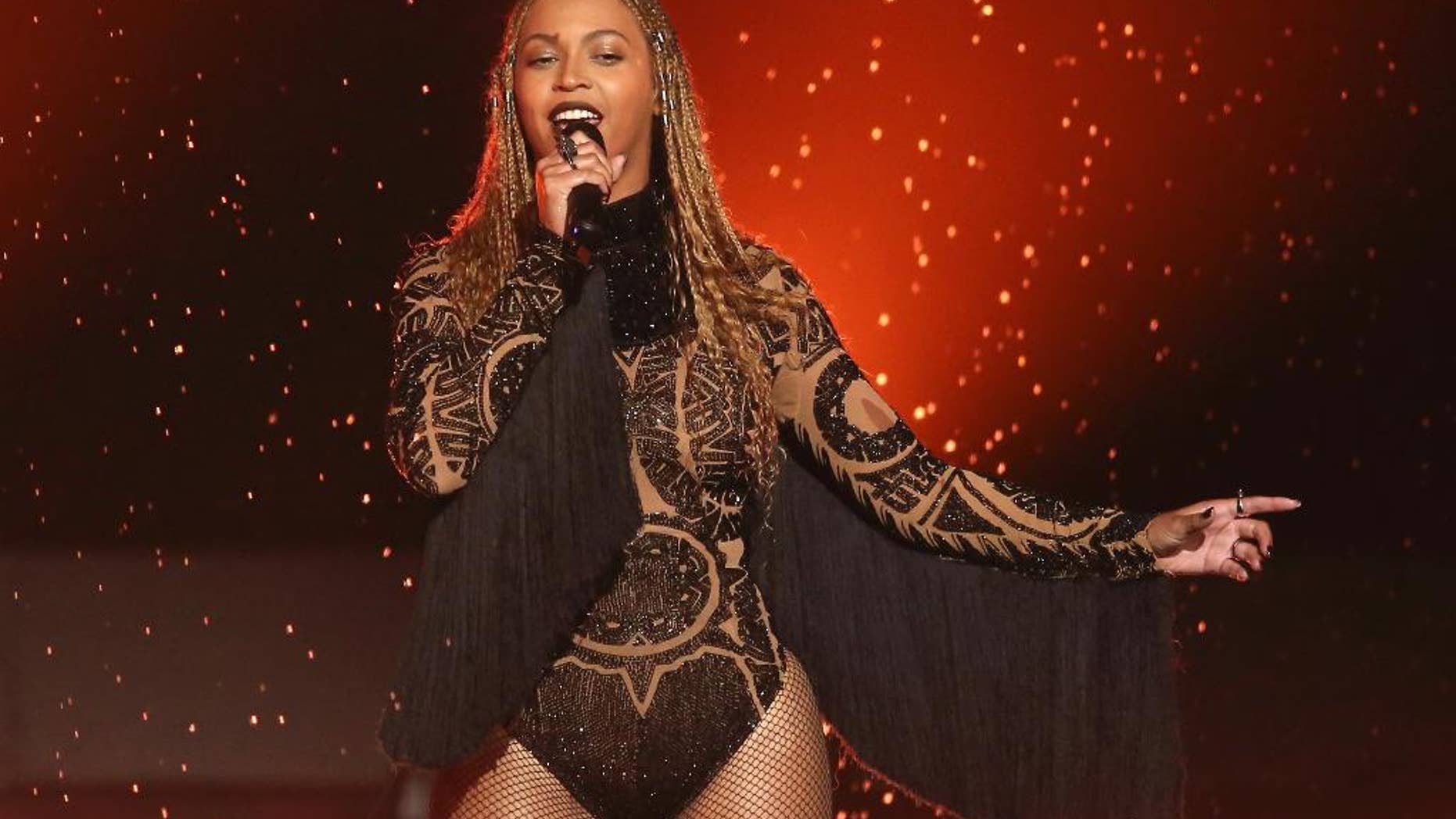 FILE - In this June 26, 2016, file photo, Beyonce performs "Freedom" at the BET Awards in Los Angeles. There are few things Beyonce has not conquered, and the Grammy for album of the year is one of them. Beyonce's main competition is Adele, who won album, song and record of the year in 2010 with "21" and "Rolling In the Deep." The 2017 Grammy Awards are held Sunday, Feb. 12, 2017. (Photo by Matt Sayles/Invision/AP, File)