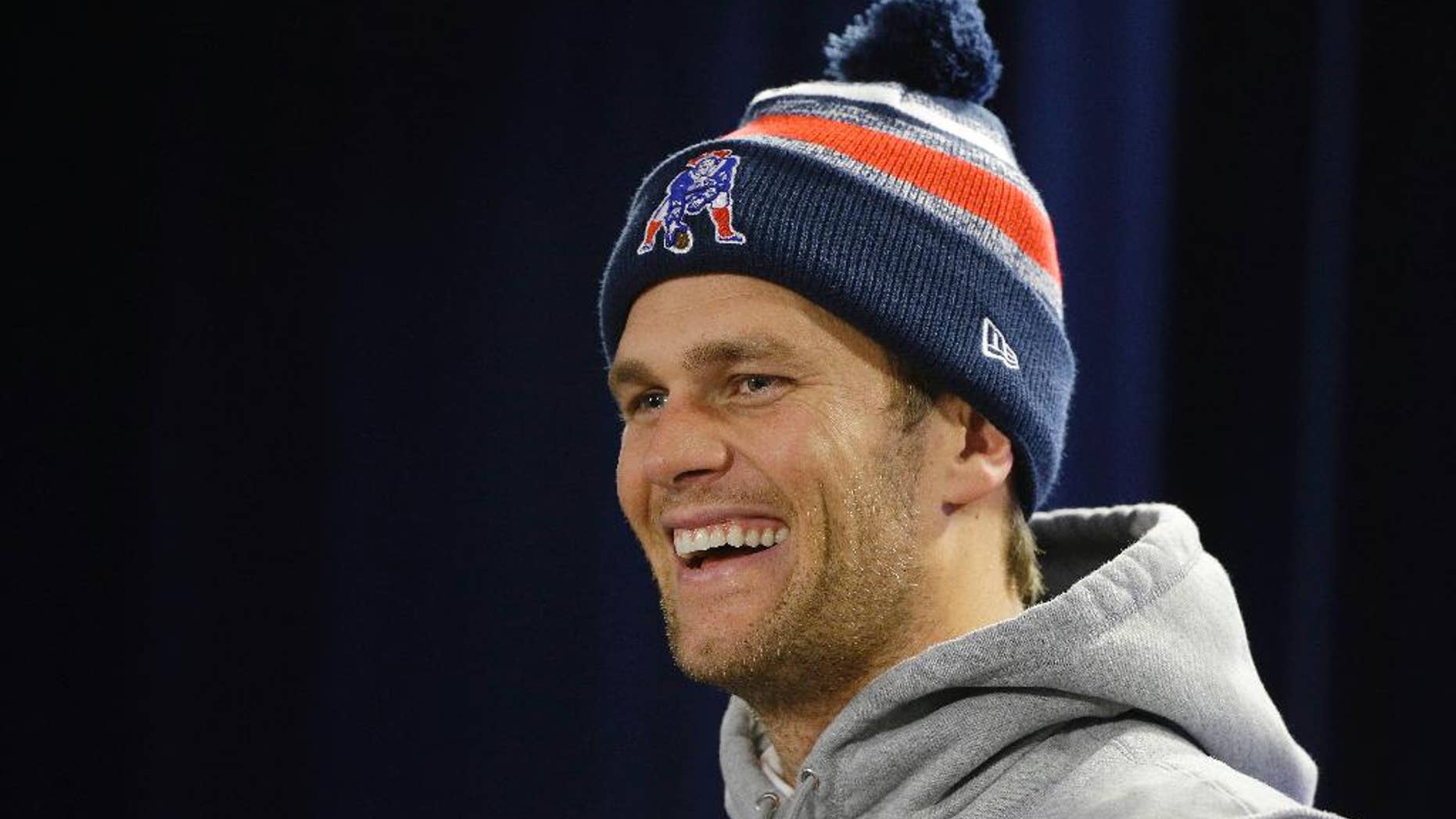New England Patriots quarterback Tom Brady laughs as he listens to a reporter's questions during a media availability at the NFL football team's facility Wednesday, Nov. 26, 2014 in Foxborough, Mass. The Patriots will play the Green Bay Packers on Sunday in Wisconsin. (AP Photo/Stephan Savoia)