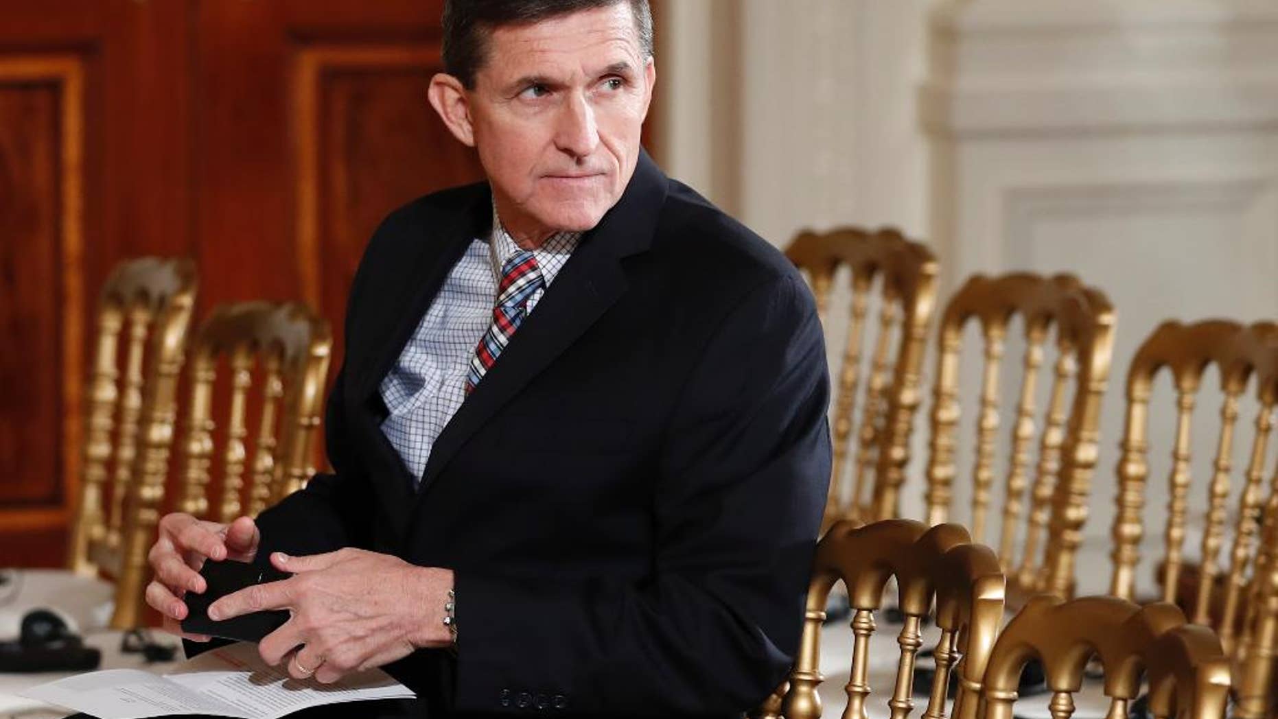 FILE - In this Feb. 10, 2017 file photo, then-National Security Adviser Michael Flynn sits in the East Room of the White House in Washington. Documents released in a congressional inquiry show Flynn was paid more than $33,750 by RT, Russia’s government-run television system, for appearing at a Moscow event in December 2015. Flynn had retired months earlier as head of the U.S. Defense Intelligence Agency. (AP Photo/Carolyn Kaster, File)
