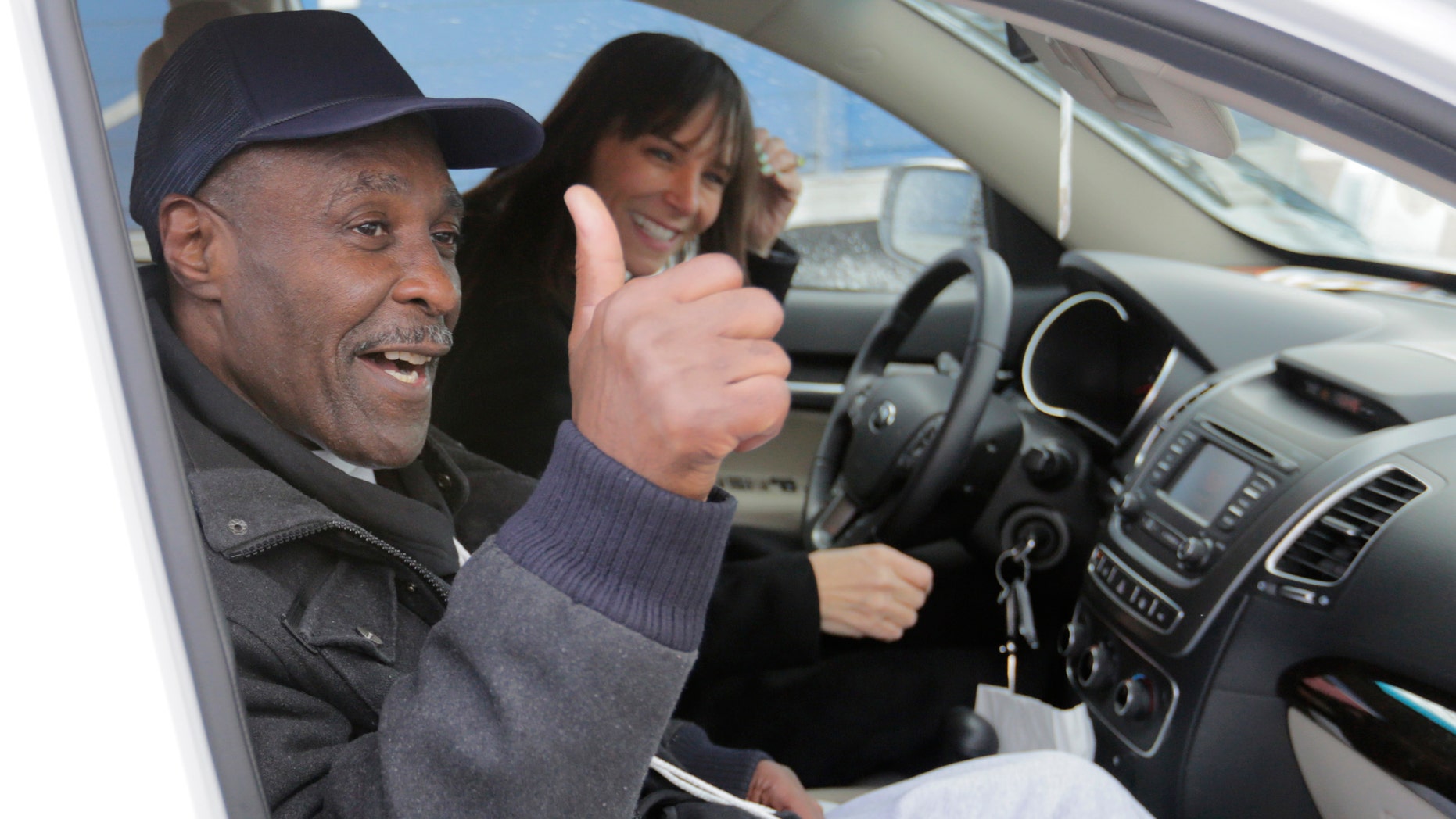 Stanley Wrice, left, convicted of rape and sentenced to 100 years in prison in 1982 gives a thumbs-up sign as he and his attorney Jennifer Bonjean, leave Pontiac Correctional Center Wednesday, Dec. 11, 2013 in Pontiac, Ill. Wrice was released after serving more than 30 years in prison when a Cook County Judge overturned his conviction the day before and granted him a new trial. Wrice has claimed for decades he was beaten and coerced into confessing to the rape by Chicago police Area 2 detectives working for disgraced former Chicago police Lt. Jon Burge. Burge himself, is now in federal prison after being convicted of perjury related to torture allegations. Judge Richard Walsh's ruling comes after the officers working for Lt. Burge who Wrice says beat him, invoked their right not to testify. (AP Photos/M. Spencer Green)