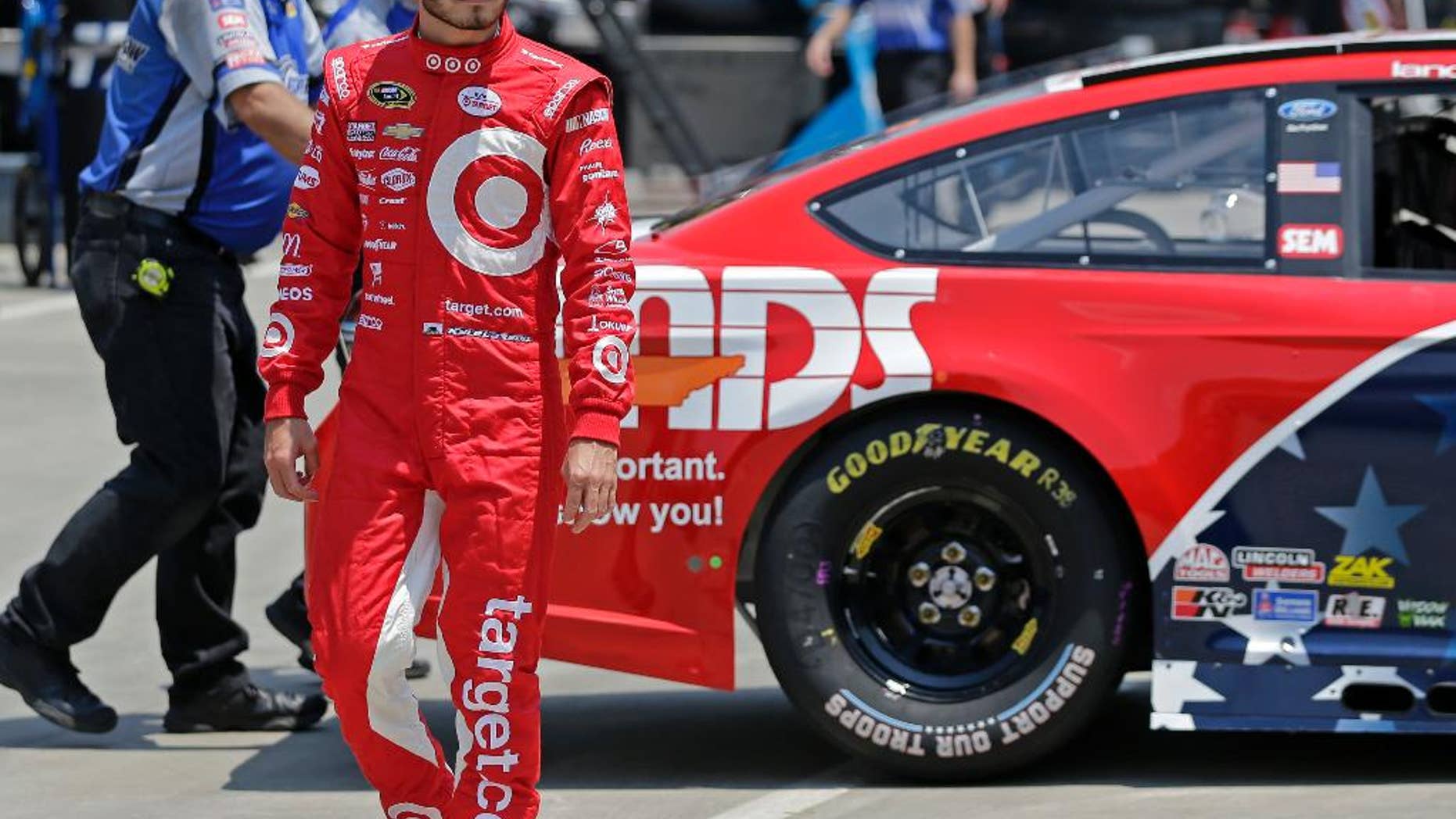 aKyle Larson walks through the garage before practice for Sunday's NASCAR Sprint Cup series auto race at Charlotte Motor Speedway in Concord, N.C., Thursday, May 26, 2016. (AP Photo/Chuck Burton)