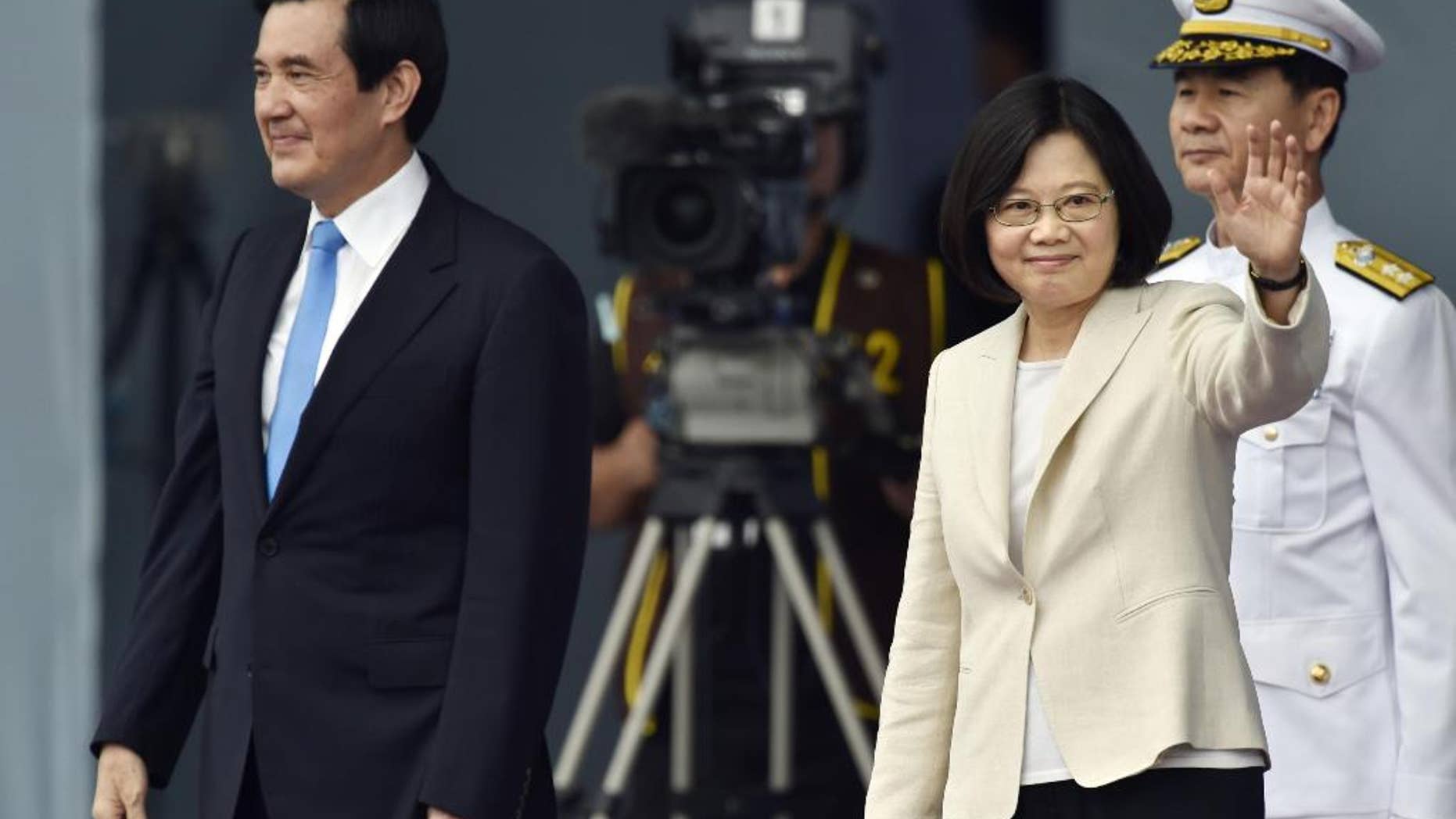 Taiwan's Tsai Ing-wen, right, waves beside incumbent President Ma Ying-jeou at the Presidential Office Building in Taipei, Taiwan, Friday, May 20, 2016. Taiwan inaugurated Tsai as its first female president on Friday, returning the pro-independence Democratic Progressive Party to power amid new concerns over increasingly fractious relations with Beijing and a flagging economy. (Minoru Iwasaki/Kyodo News via AP) JAPAN OUT, CREDIT MANDATORY