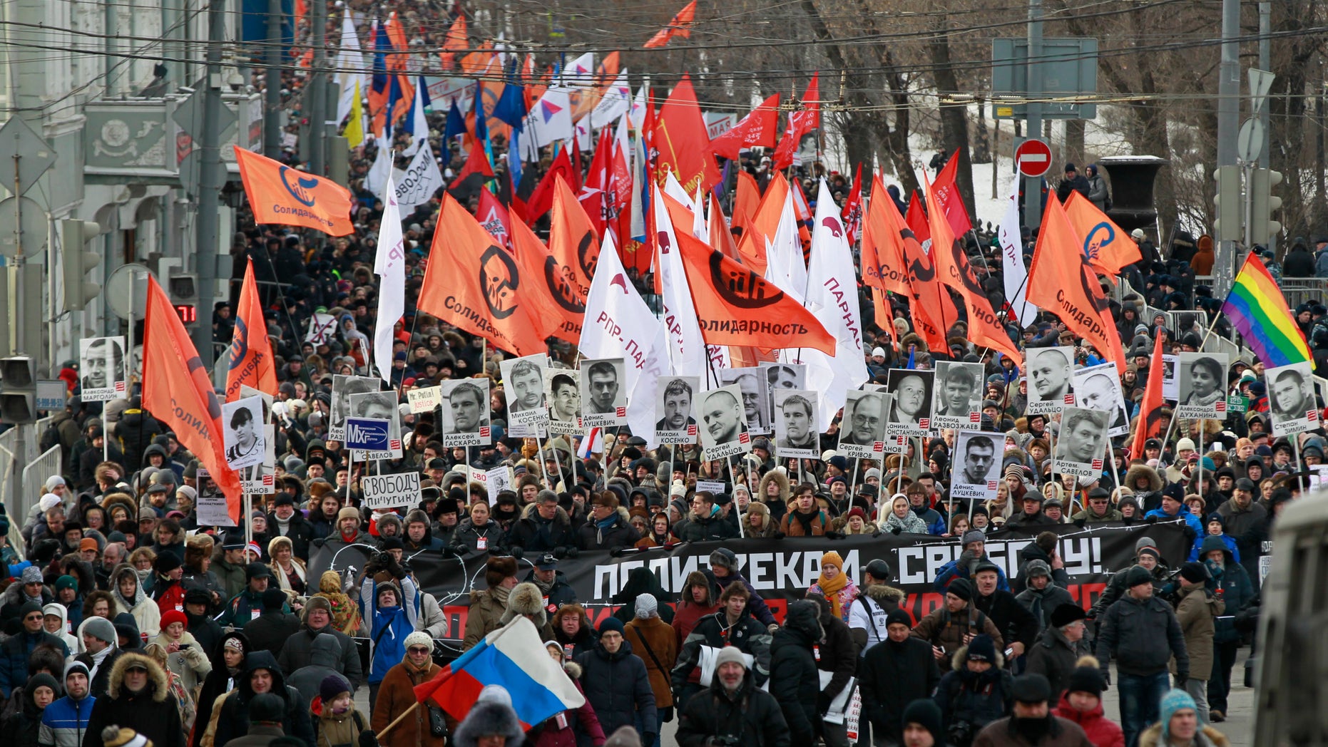 Feb. 2, 2014: Opposition demonstrators carry posters of imprisoned protesters during a protest rally in Moscow, Russia. Several thousand Russian opposition supporters gathered for a protest on Sunday, venting anger against the Kremlin and demanding the release of political prisoners.