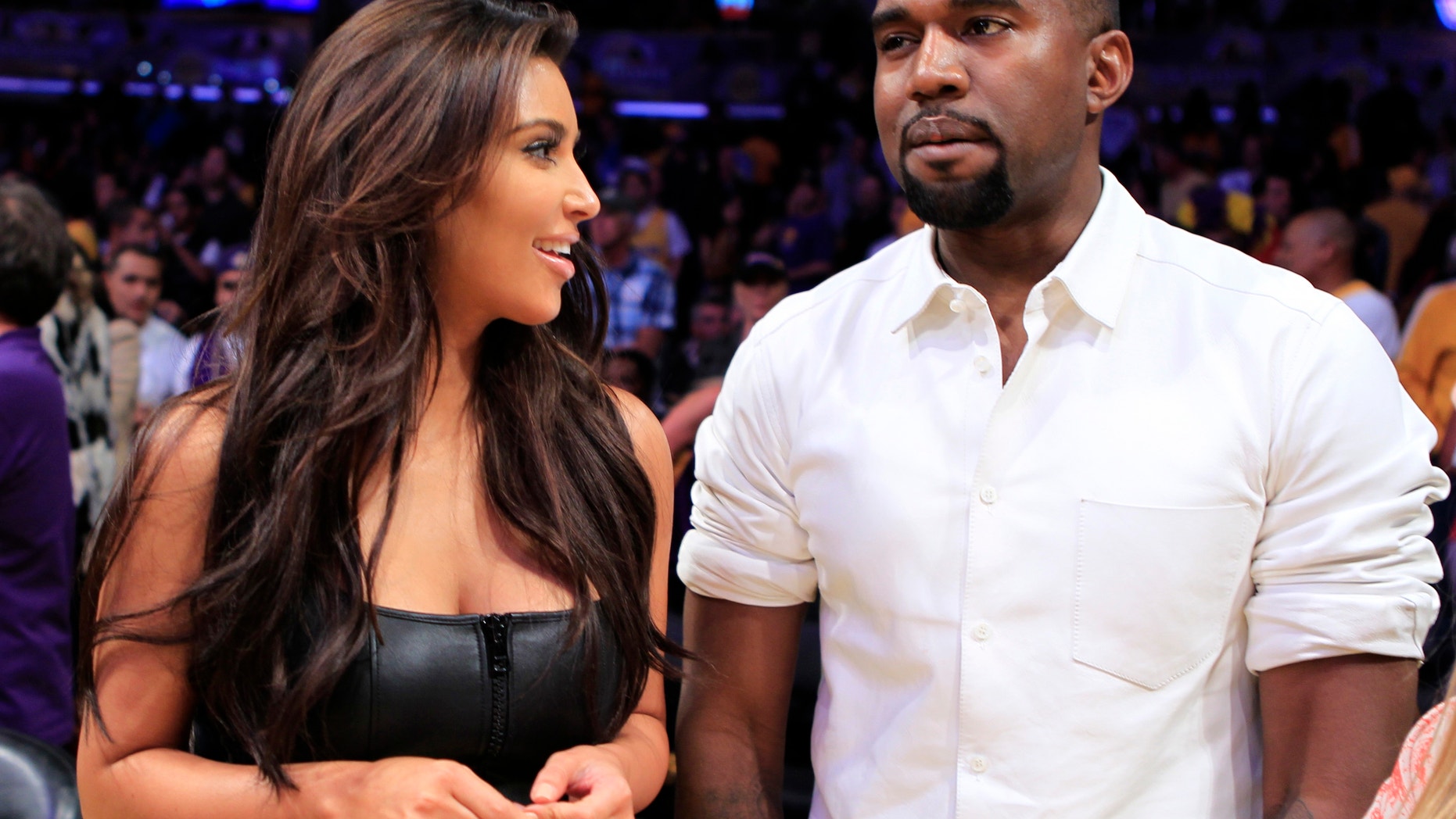Kim Kardashian and musician Kanye West watch the Los Angeles Lakers play the Denver Nuggets in Los Angeles, California May 12, 2012.