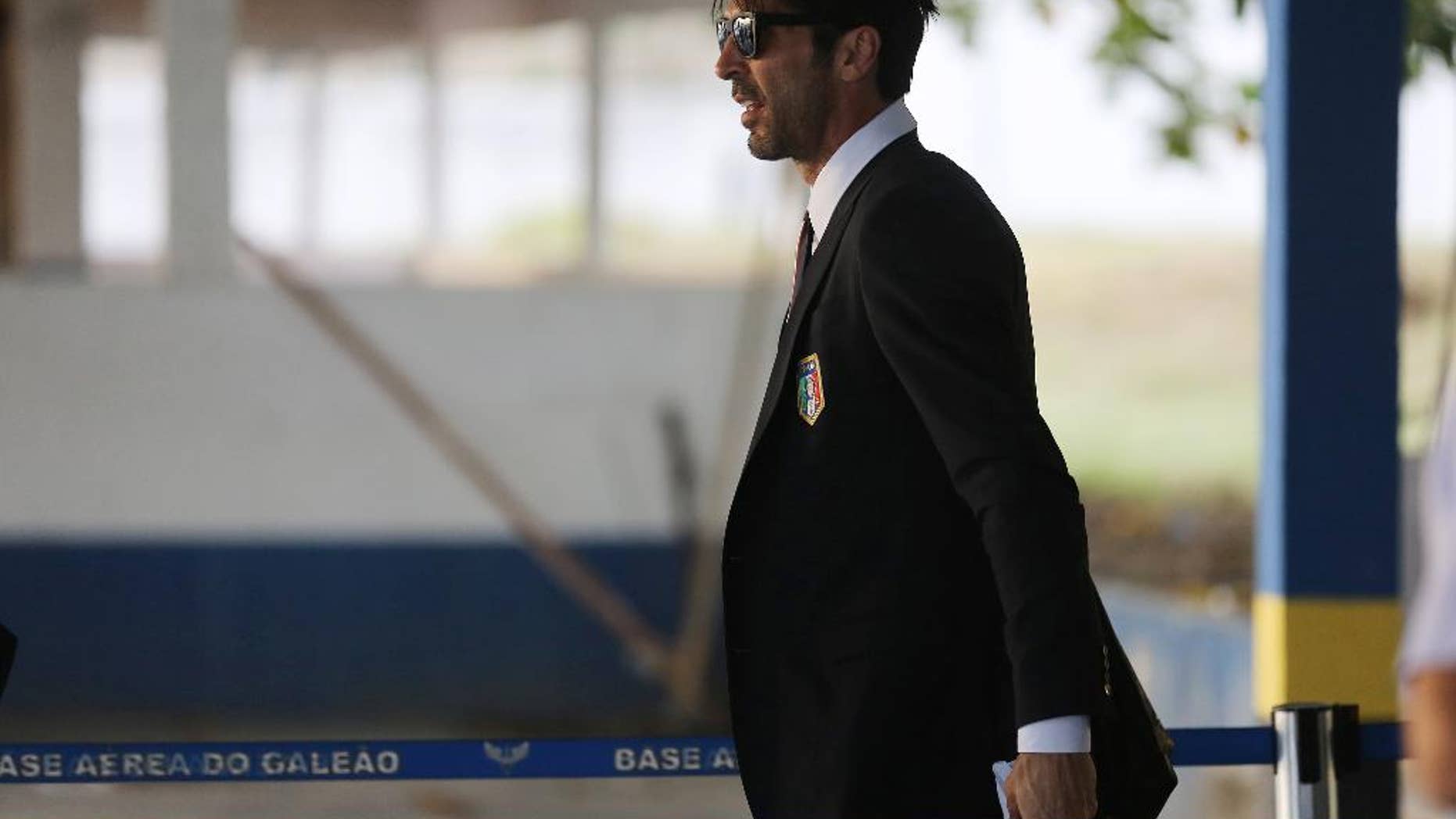 Italy's Gianluigi Buffon walks to his team's bus after arriving to the Galeao Air Base for the World Cup in Rio de Janeiro, Brazil, Friday, June 6, 2014. The Italian team will be based at a resort in Mangaratiba during the World Cup. (AP Photo/Leo Correa)