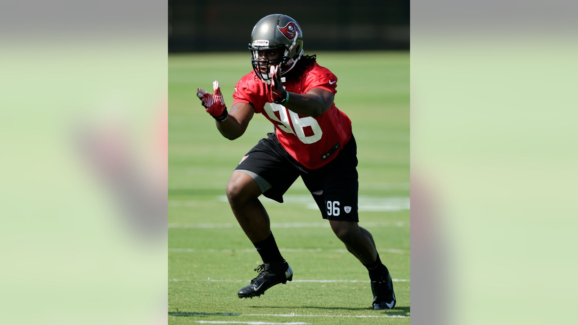 Tampa Bay Buccaneers defensive end Steven Means runs through a drill during an optional NFL football team workout Monday, May 20, 2013, in Tampa, Fla. (AP Photo/Chris O'Meara)