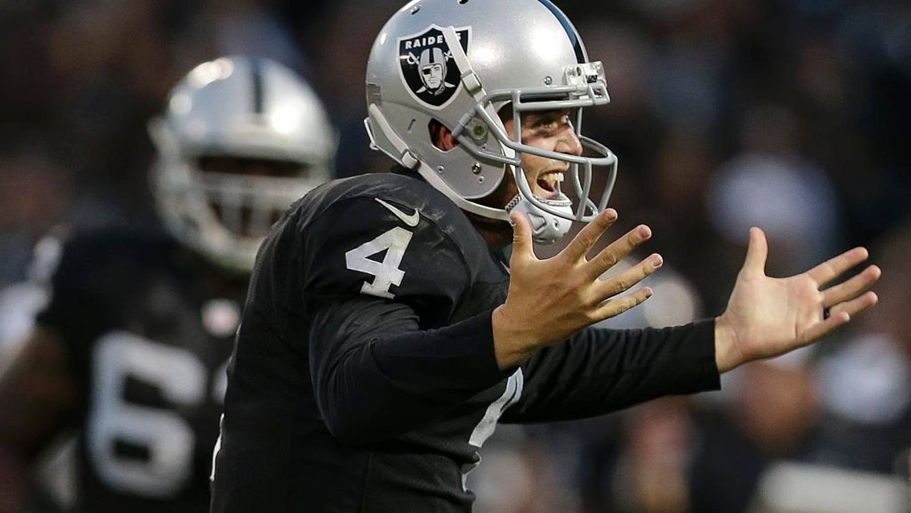 Oakland Raiders quarterback Derek Carr, right, celebrates after throwing a 20-yard touchdown pass to Mychal Rivera against the Seattle Seahawks during the first half of an NFL preseason football game in Oakland, Calif., Thursday, Aug. 28, 2014. (AP Photo/Marcio Jose Sanchez)